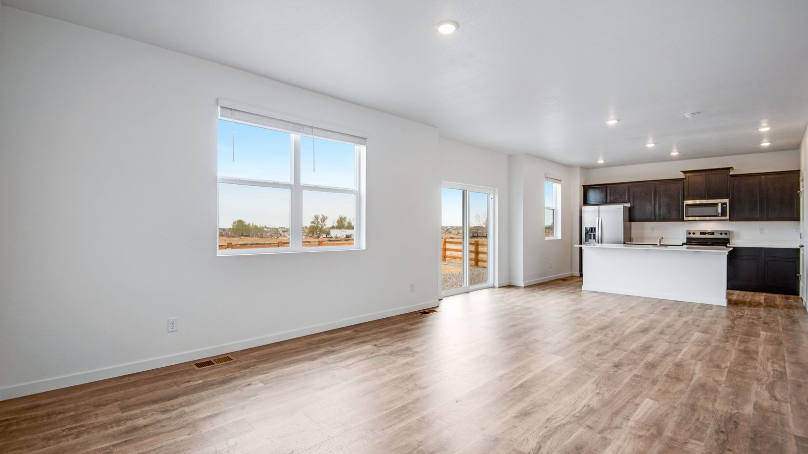 Living room with large windows in new D.R. Horton home in Fort Lupton, Colorado