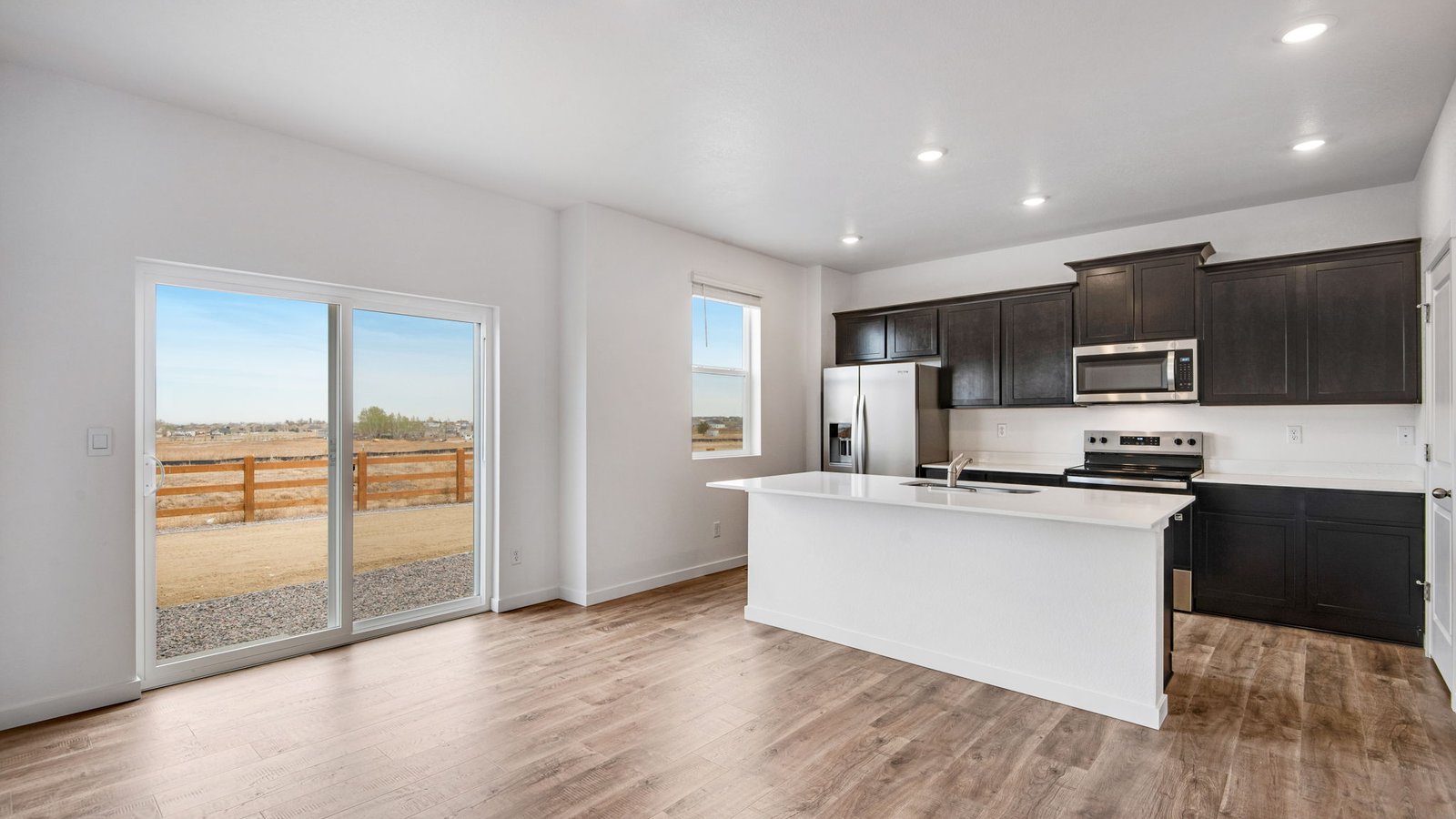 Kitchen opening up to backyard in new home in Fort Lupton, Colorado