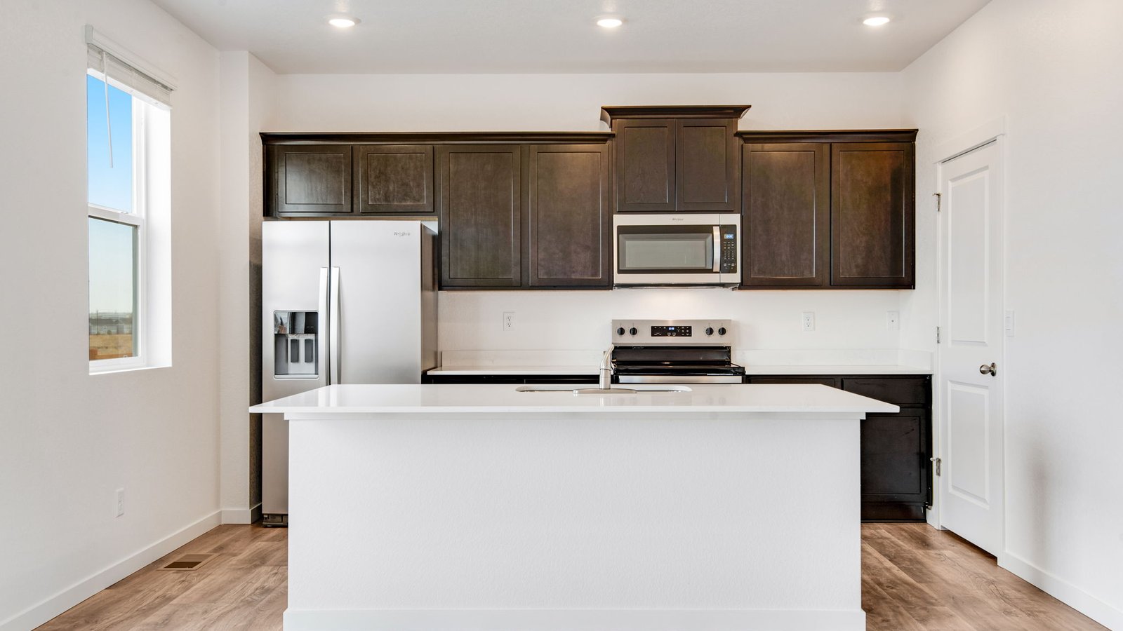 Spacious kitchen with brownstone finishes in new pendleton floor plan