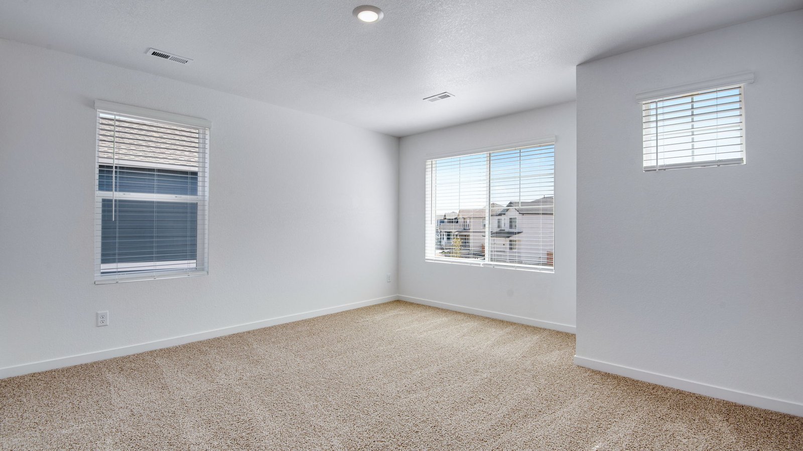 Secondary bedroom with large windows in new home at Vista Meadows community in Colorado
