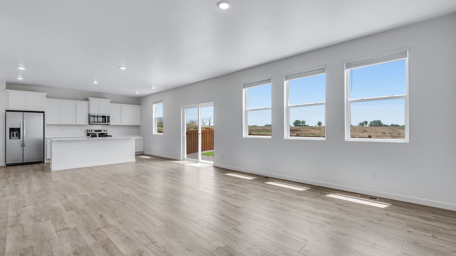 Living room with large windows in new D.R. Horton home at Fort Lupton Colorado new home community