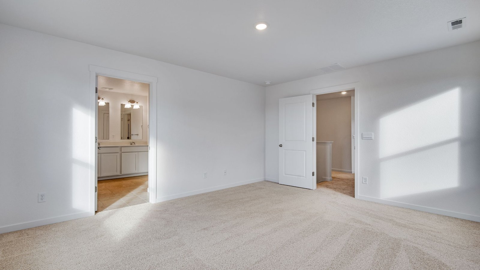 Primary bedroom with attached bathroom in Vista Meadows community