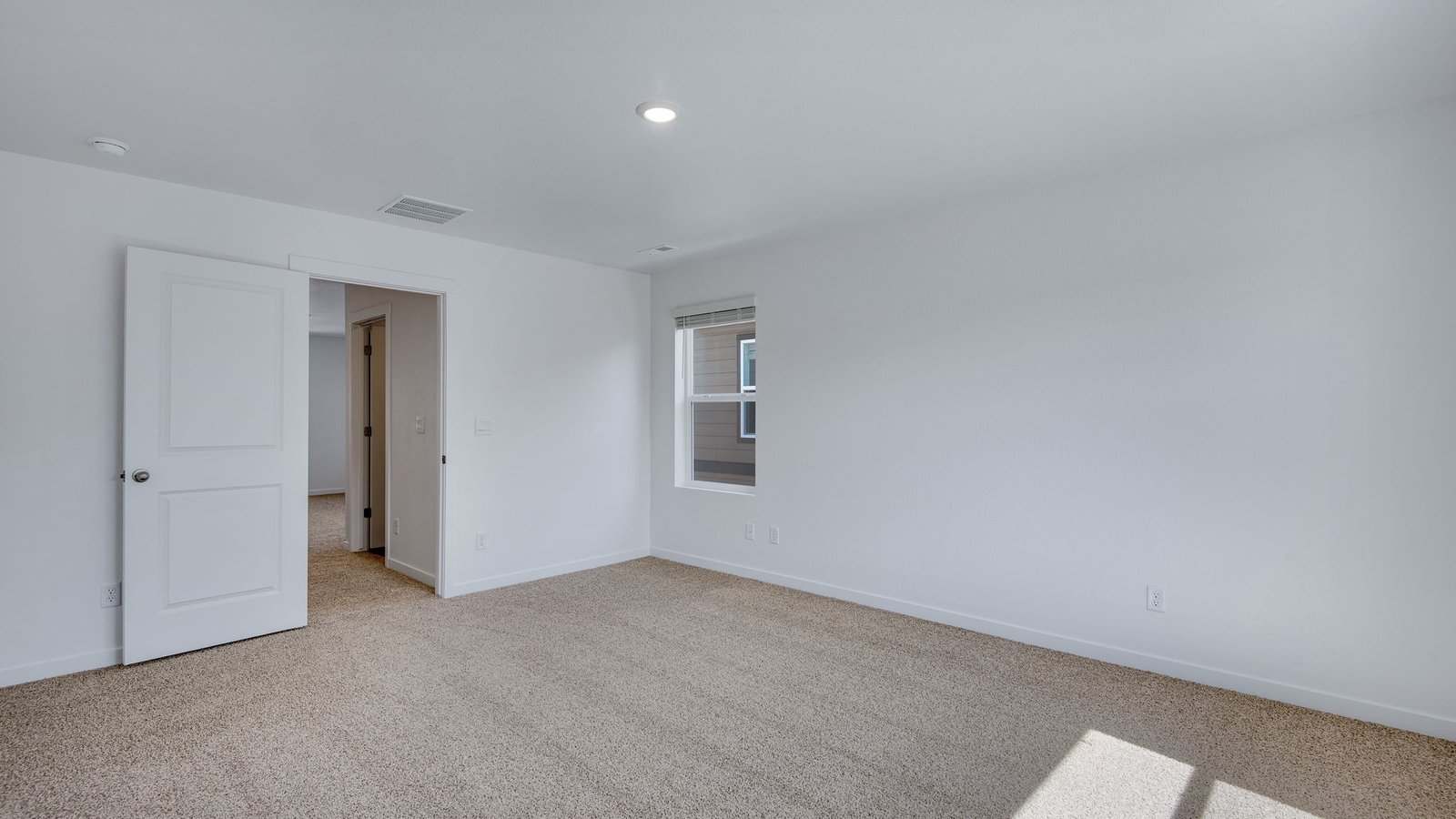 Spacious Primary bedroom with large windows at Vista Meadows Community in Fort Lupton Colorado