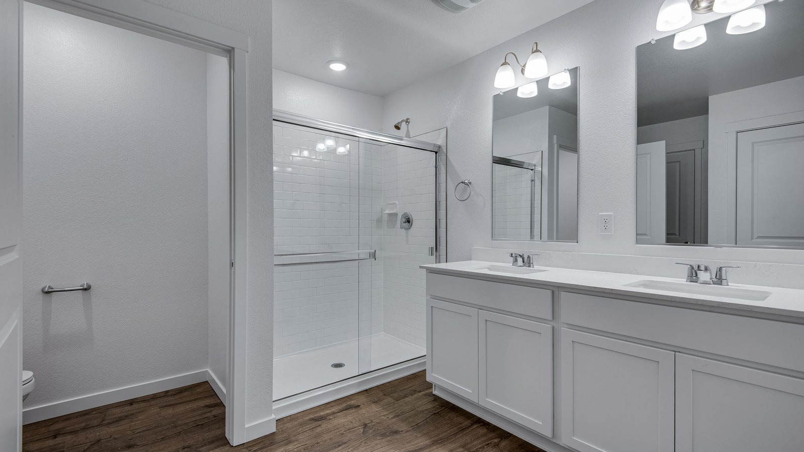 Attached primary bathroom with dual vanity sinks in new home community Vista Meadows in Fort Lupton Colorado