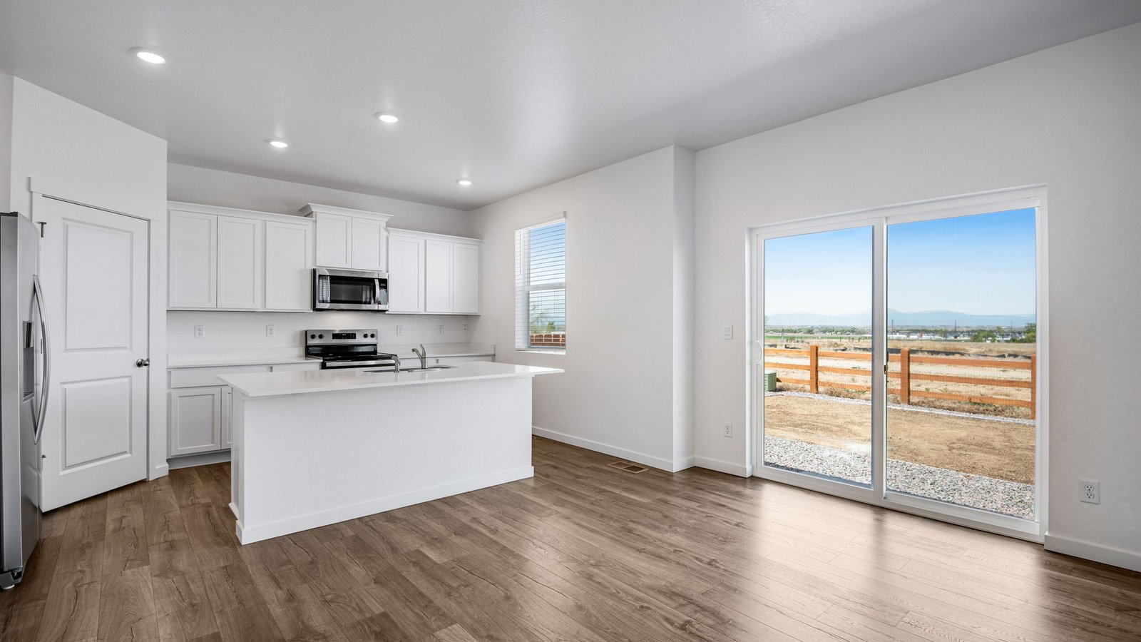 kitchen with white cabinets in new construction home by d.r. horton