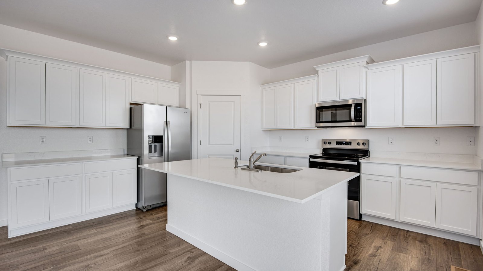 kitchen with stainless steel appliances in new construction home by d.r. horton