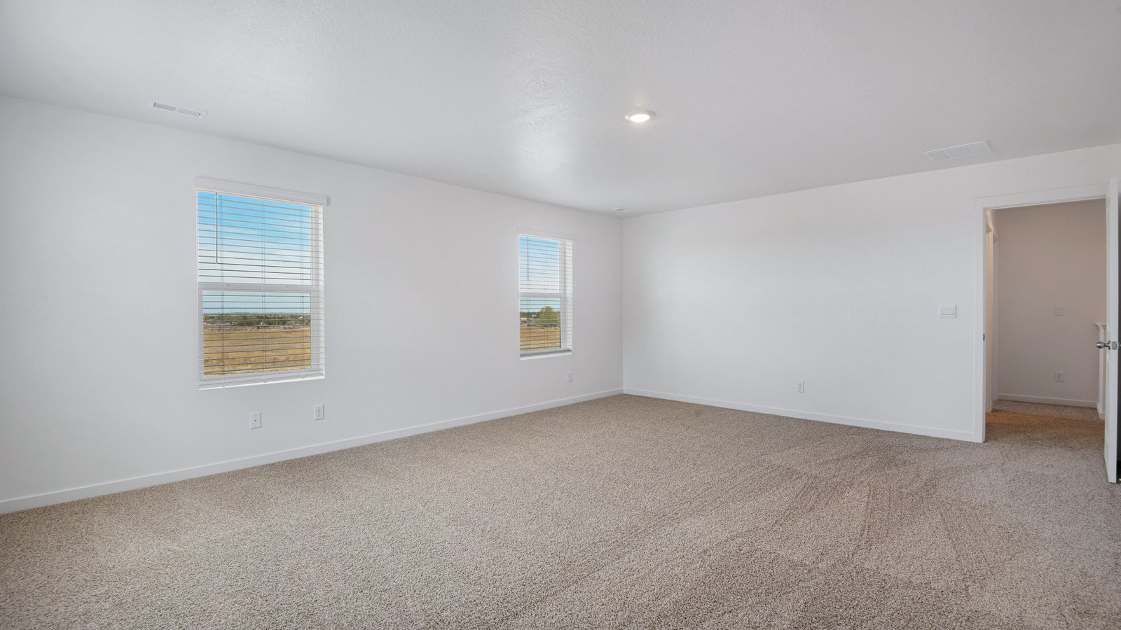primary bedroom with ensuite in new fort lupton home
