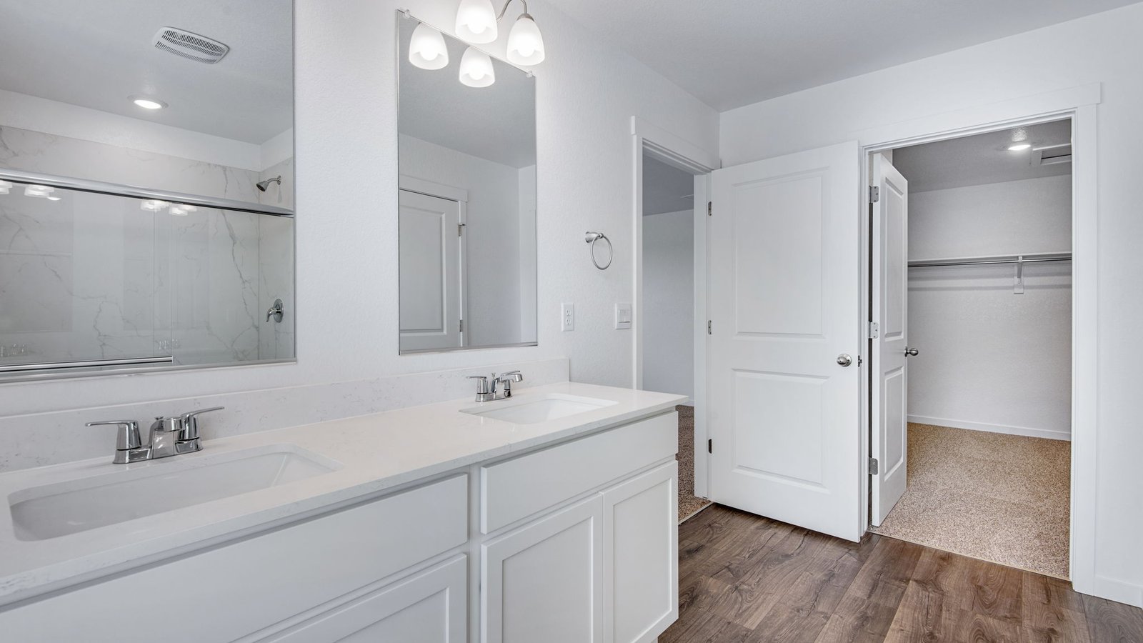 walk-in closet and primary bath in new construction home in fort lupton, co