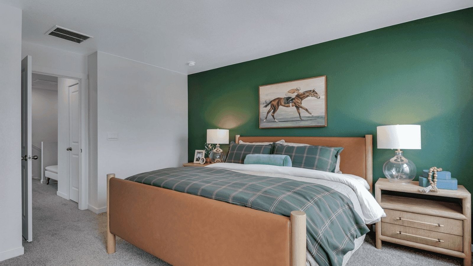 primary bedroom with green wall in new construction home fort lupton, co