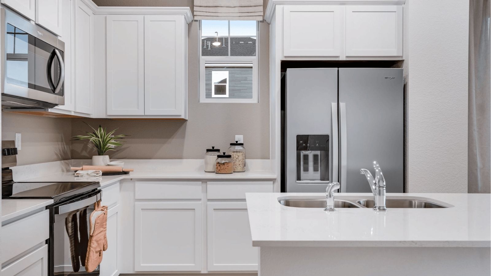 kitchen with stainless steel refrigerator in new vista meadows paired home fort lupton, co