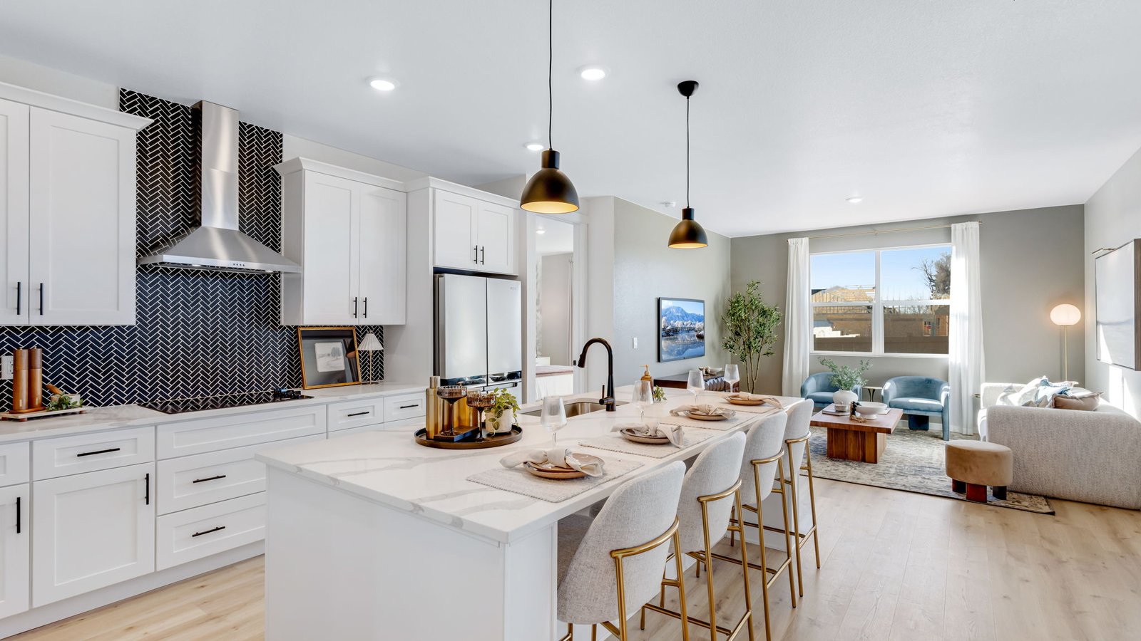 Kitchen with center island, modern cabinetry, stainless steel appliances, and open layout overlooking the main living space.