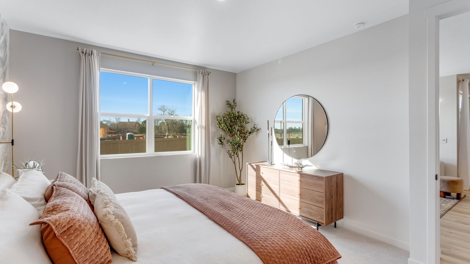 Primary bedroom with spacious layout, large window, and neutral carpet designed for comfort and natural light.