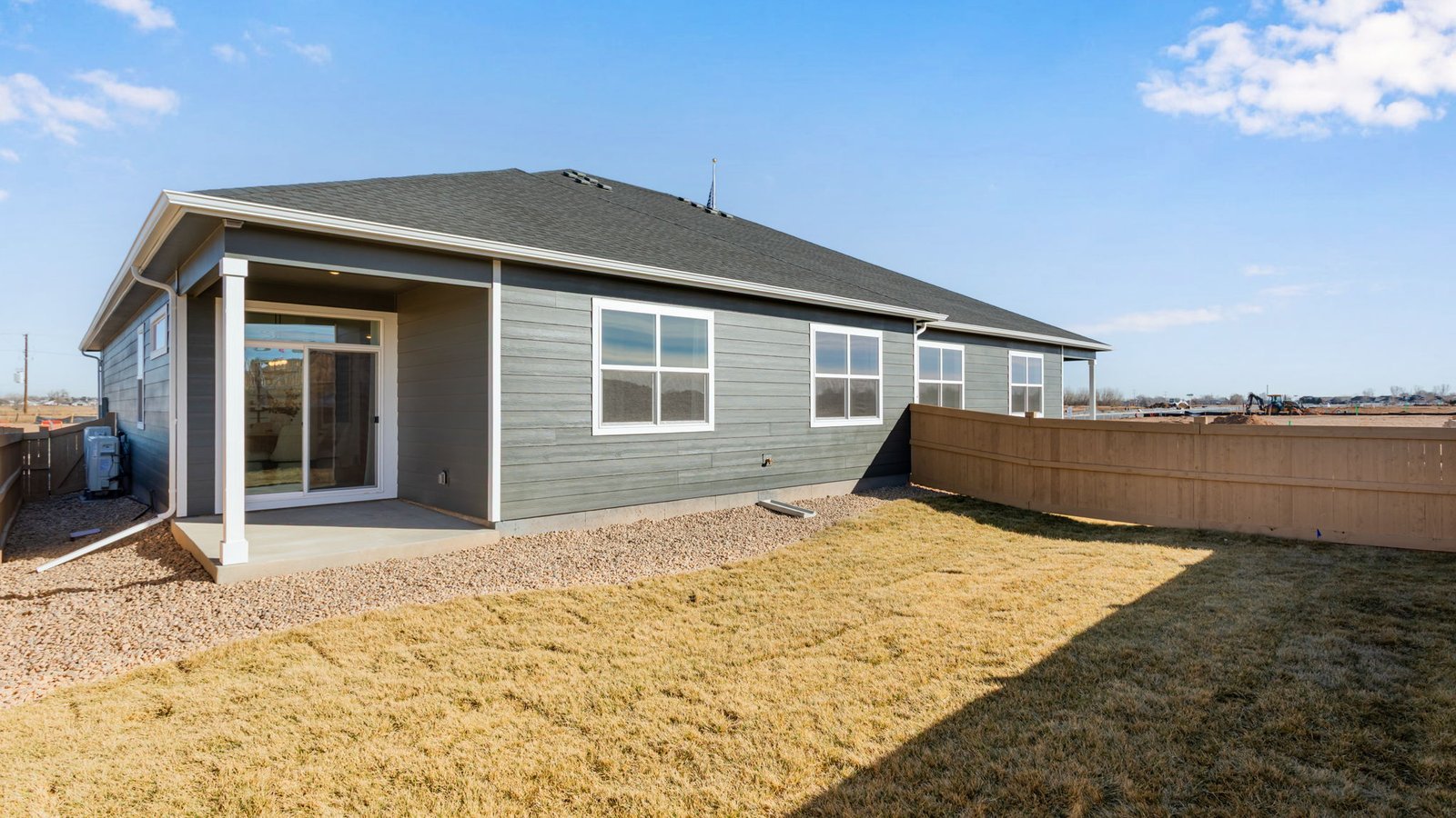 Backyard with fenced outdoor space and covered patio area designed for outdoor seating and relaxation.