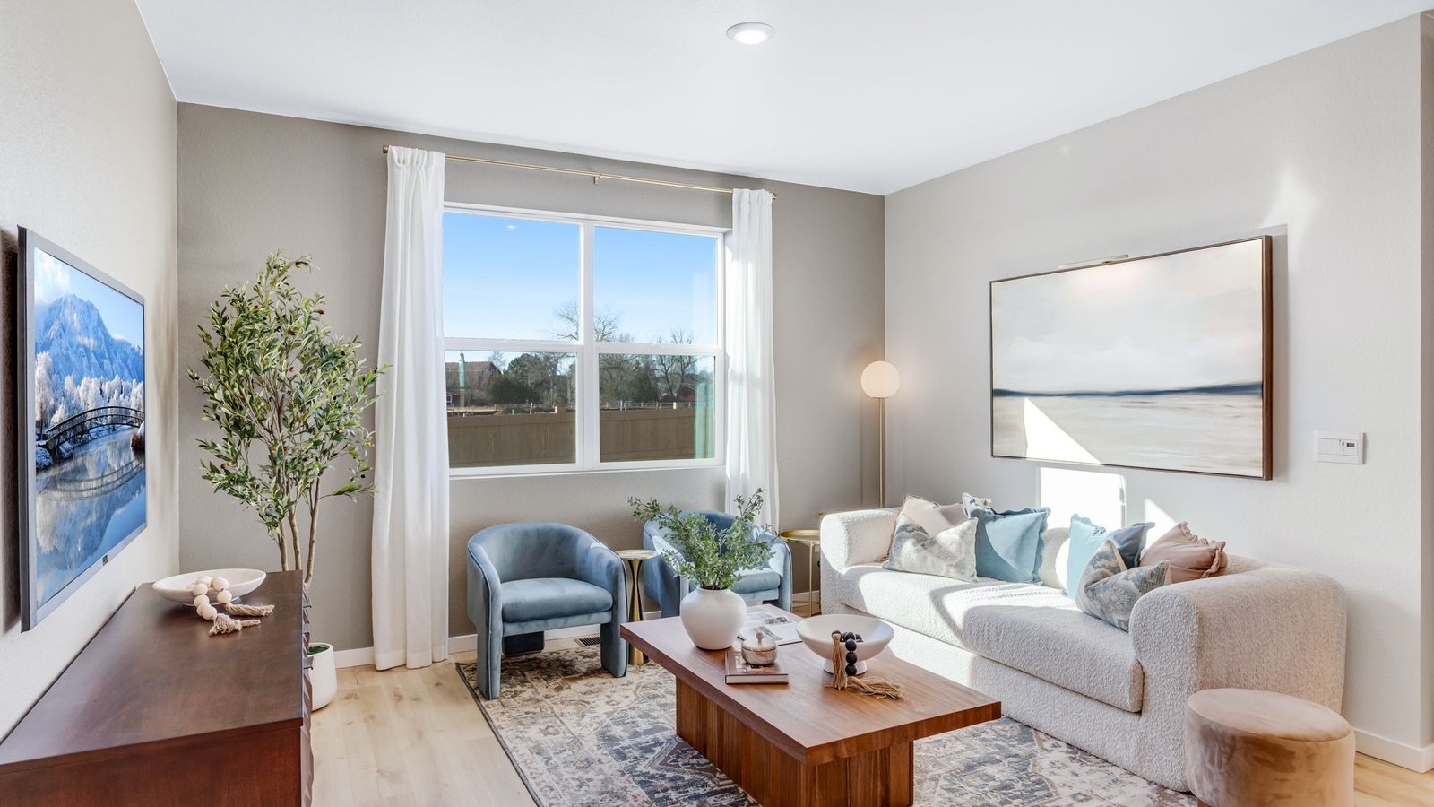 Spacious living area connected to the kitchen and dining room in a thoughtfully designed single-story home.
