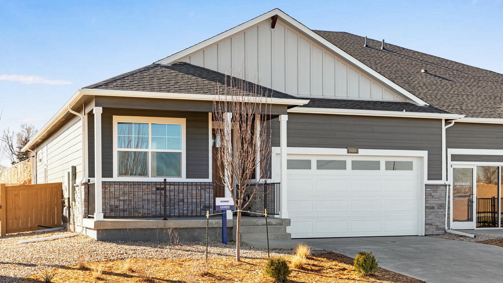 modern paired-home architecture, landscaped front yard, and attached two-car garage.