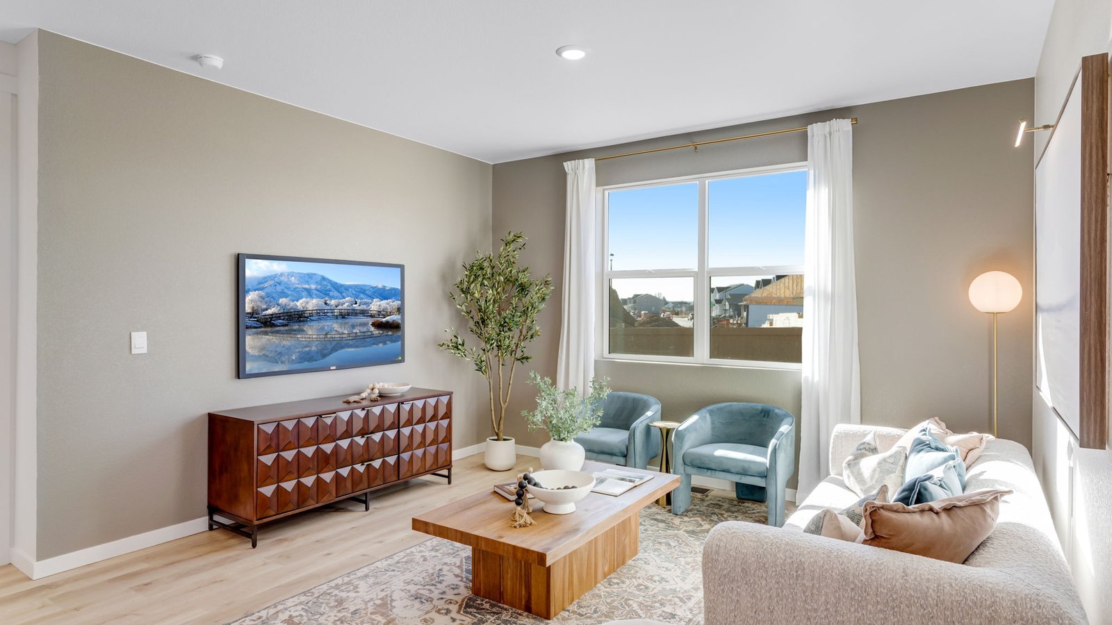 Open great room with abundant natural light and views of the backyard.