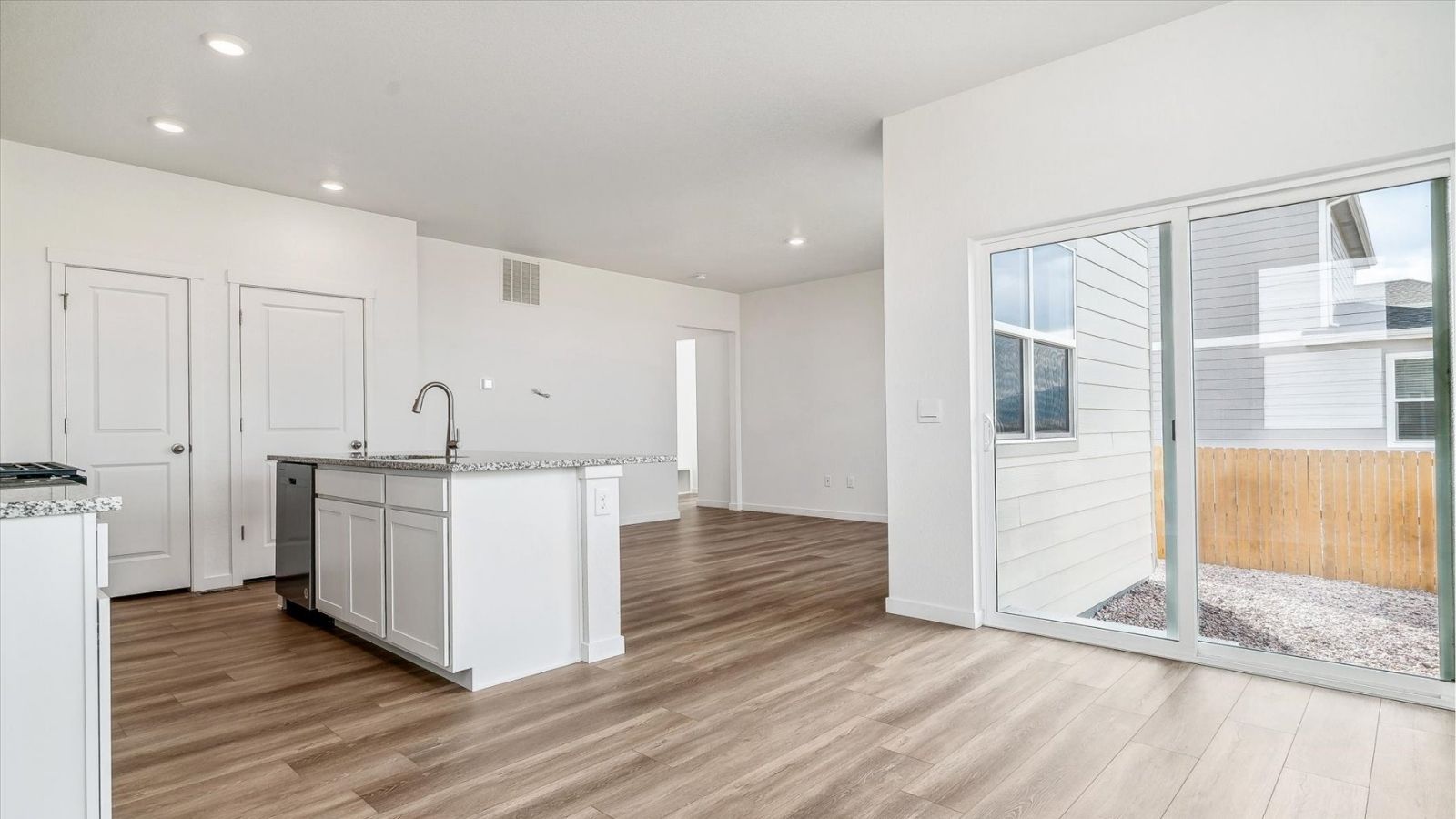 Dining nook with natural light and backyard views in a new two‑story home in Johnstown, CO.