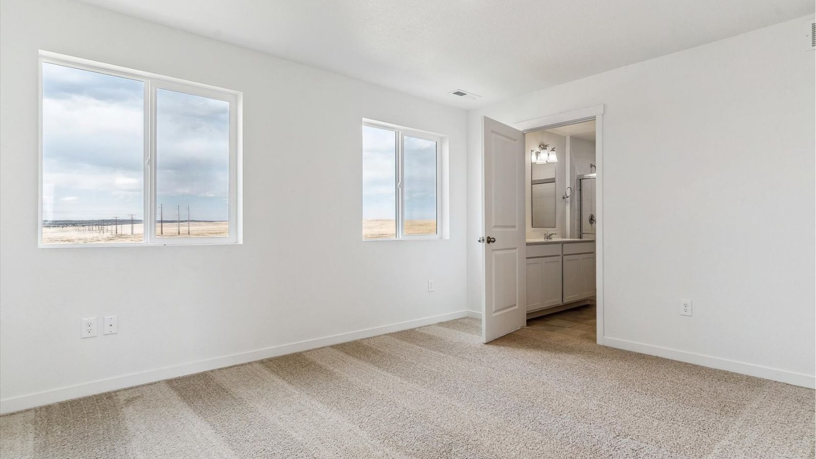 Primary bedroom with spacious layout and natural light in the Cabral floorplan at The Ridge at Johnstown.