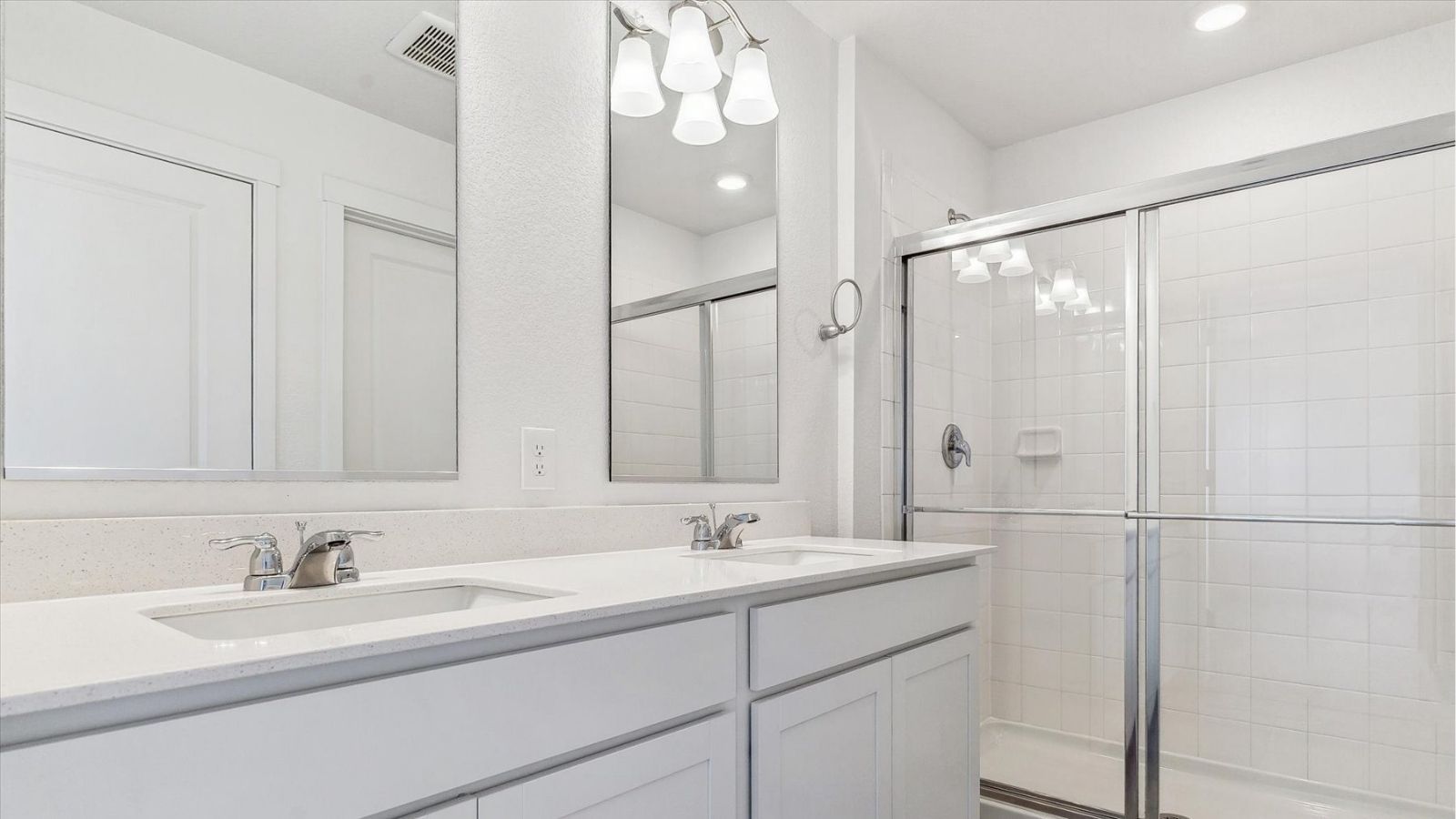 Primary bathroom with dual‑sink quartz vanity, walk‑in shower, and modern finishes in the Cabral floorplan.