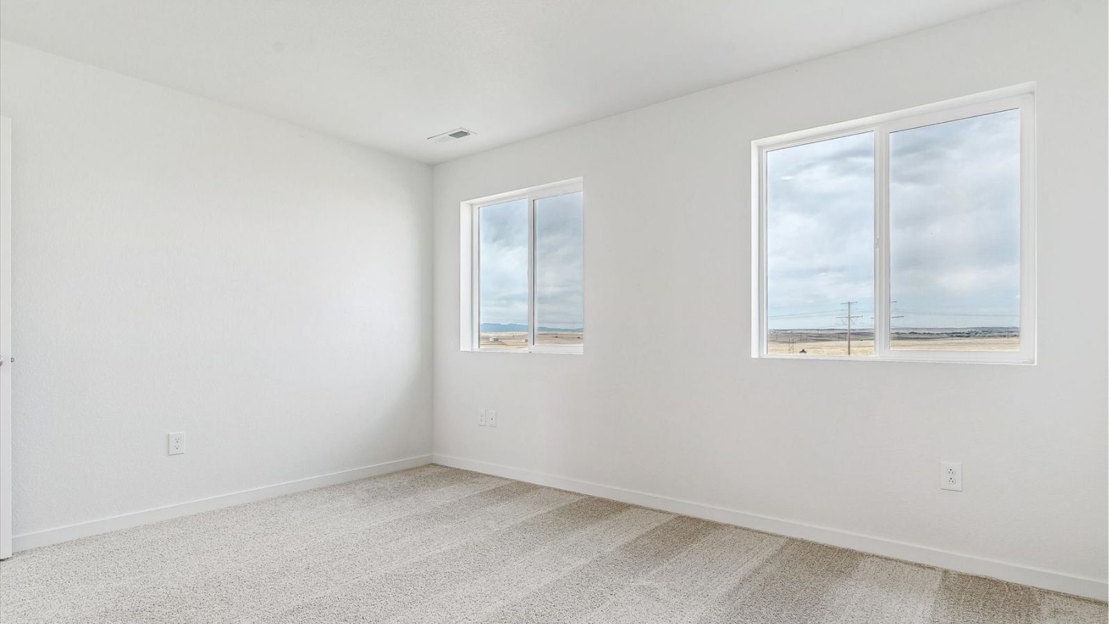 Upstairs bedroom designed for guests or flexible use in a two‑story home in Johnstown, CO.