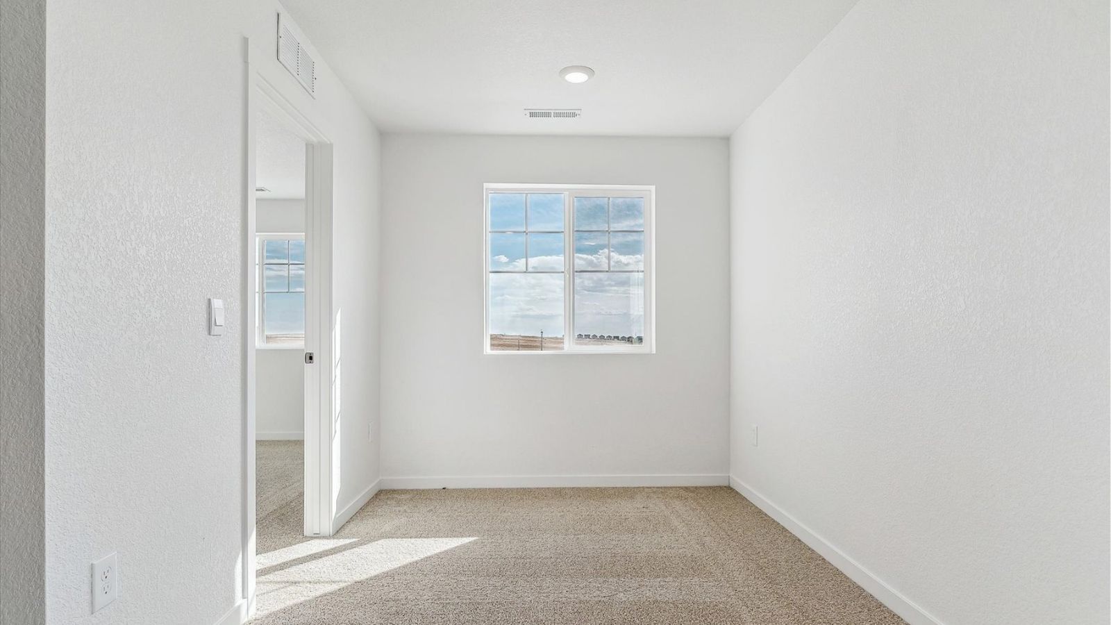 Upstairs bedroom designed for guests or flexible use in a two‑story home in Johnstown, CO.