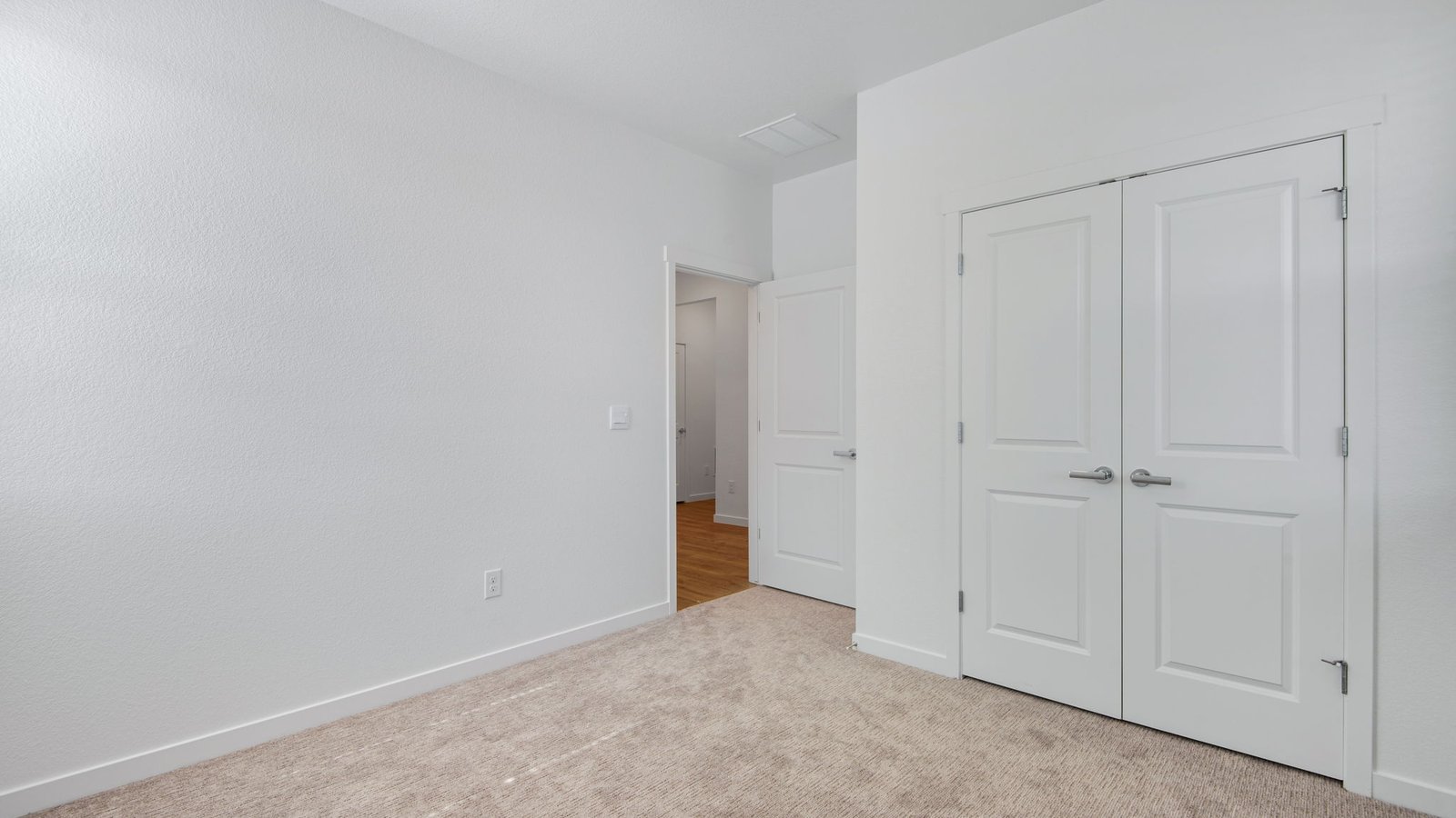 Bright secondary bedroom in the Harmony floor plan with modern finishes and versatile functionality.