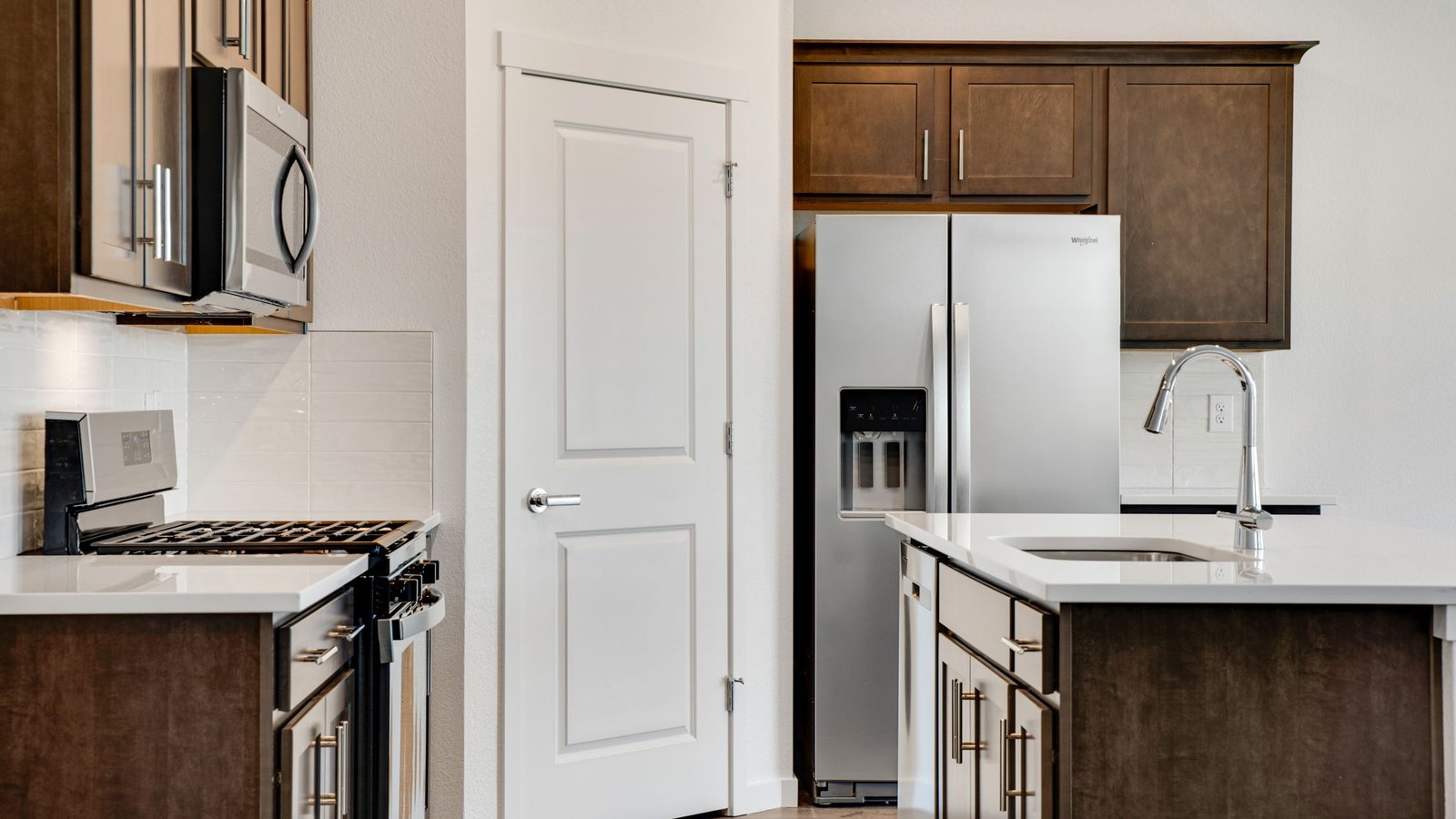 Modern kitchen in the Harmony floor plan featuring a large center island, stainless steel appliances, ample cabinetry, and an open layout ideal for entertaining.