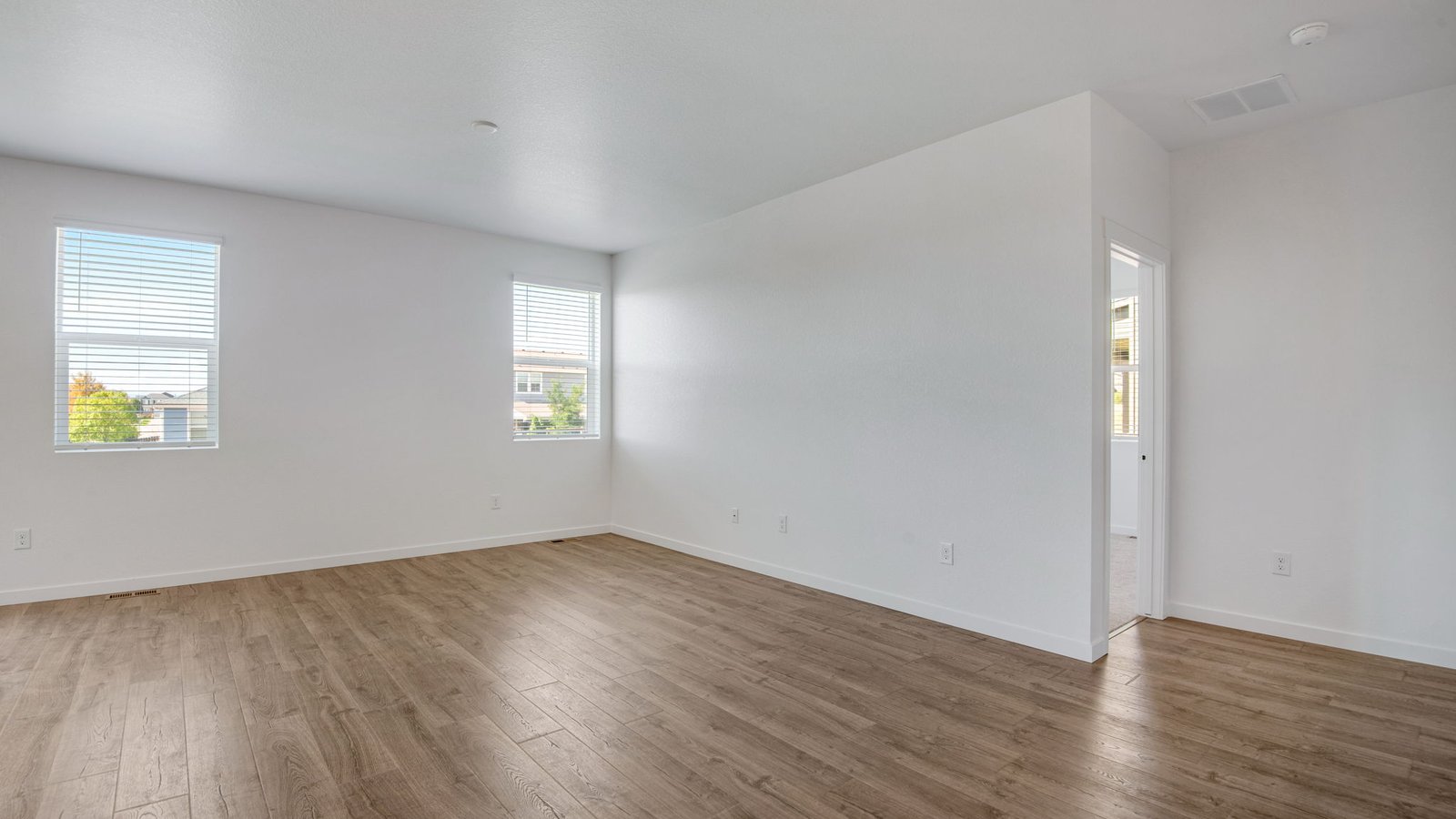 Great room overlooking the kitchen and dining area in the Harmony floor plan, showcasing connected living spaces and modern design.