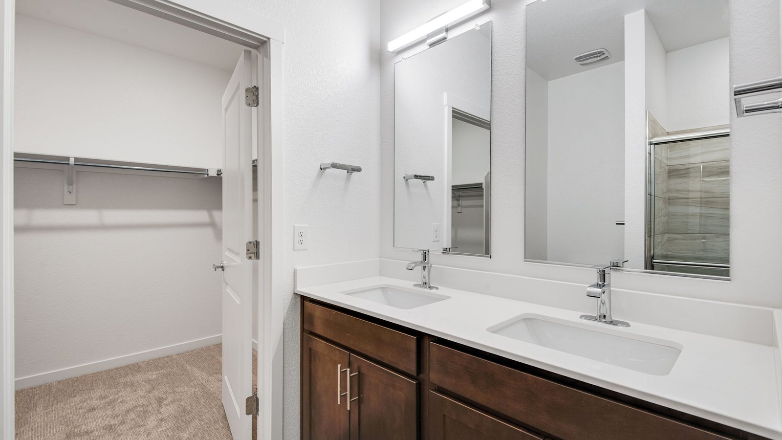 Private primary bathroom in the Harmony floor plan with dual sinks, modern fixtures, and a functional layout.