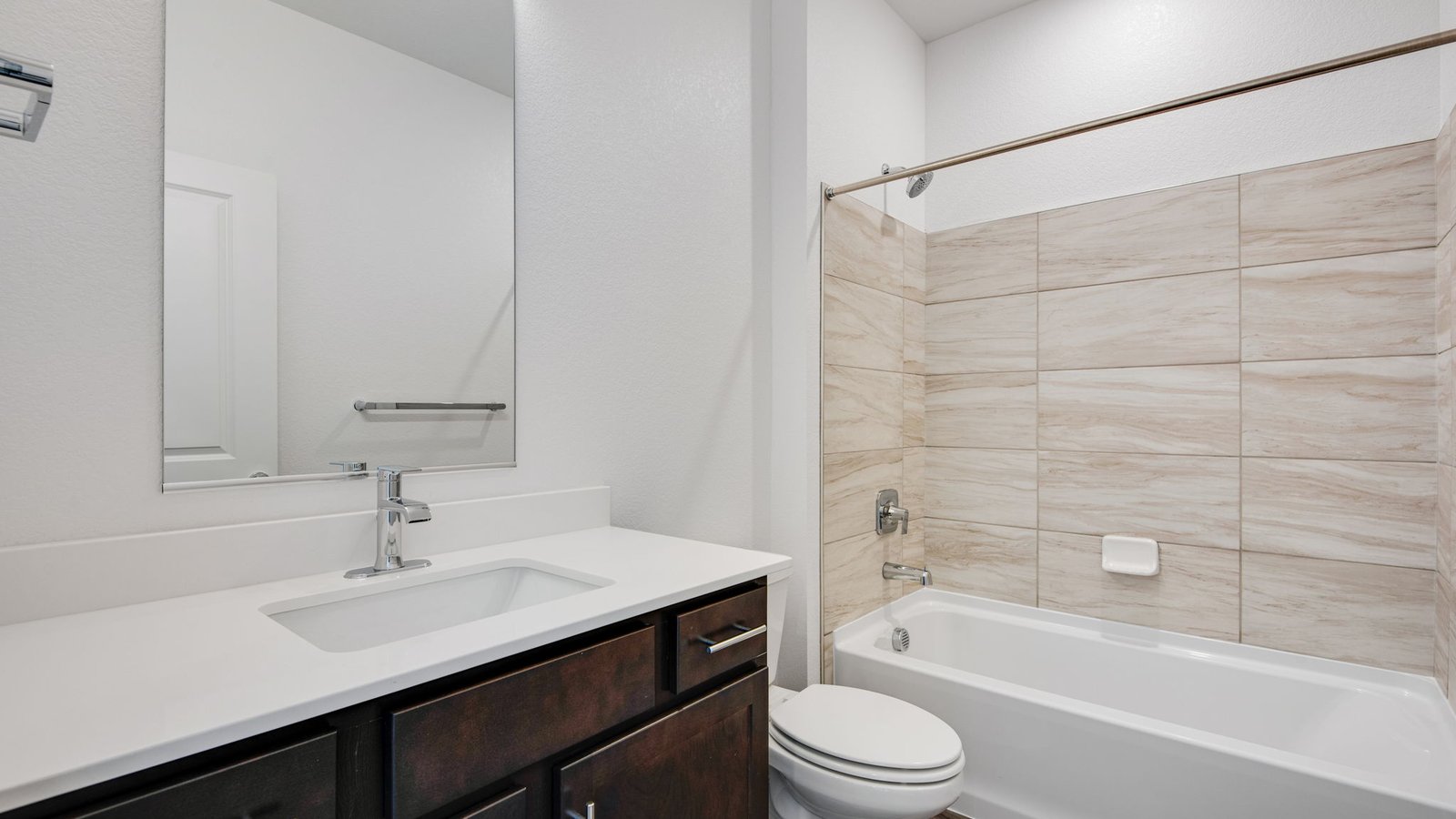 Full secondary bathroom in the Harmony floor plan featuring modern fixtures, ample counter space, and convenient access to nearby bedrooms.