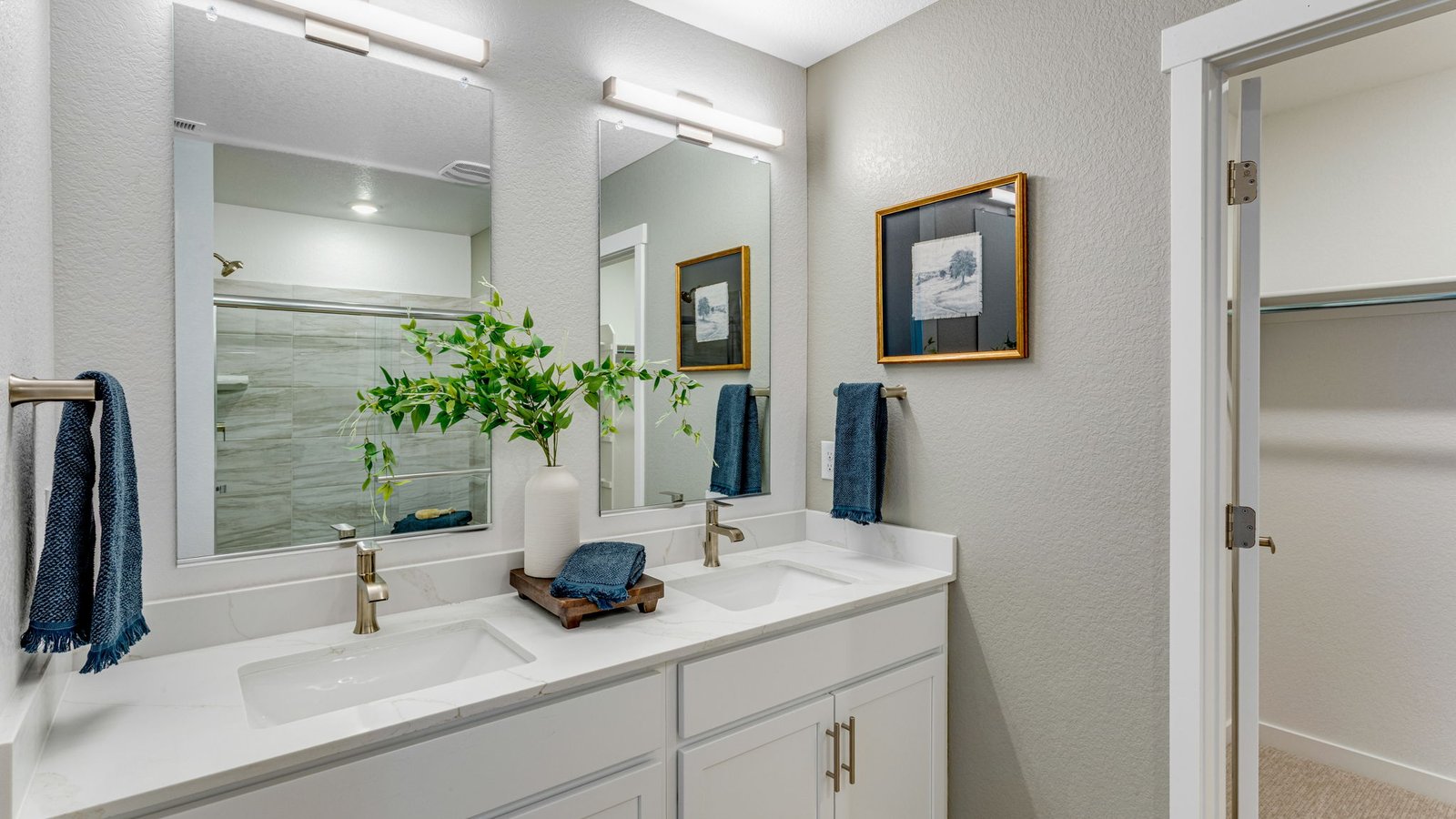 Well-appointed primary bathroom with dual sinks and modern finishes.