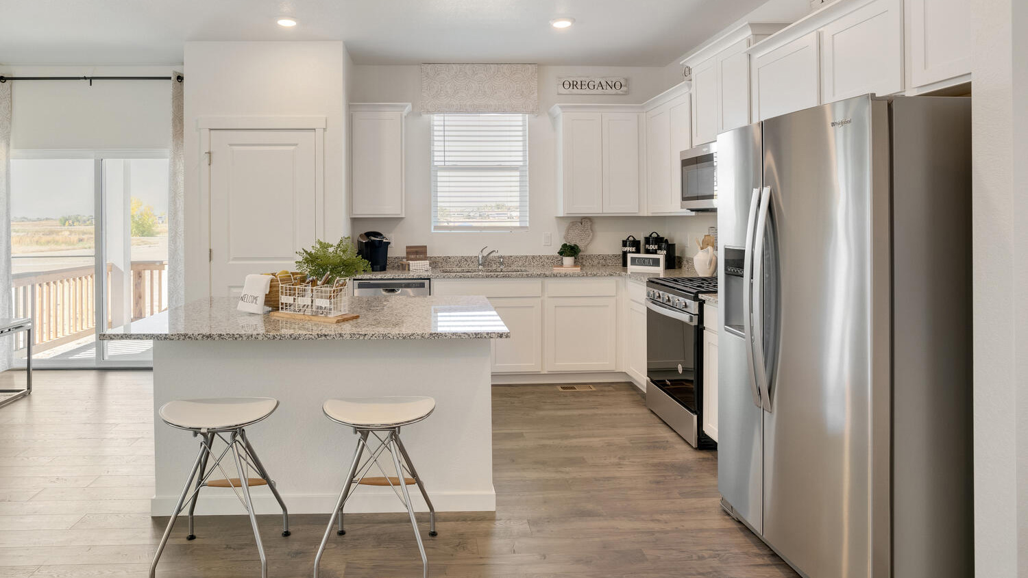 Modern kitchen in the Elder floor plan featuring a large island, abundant cabinetry, and an open-concept design.