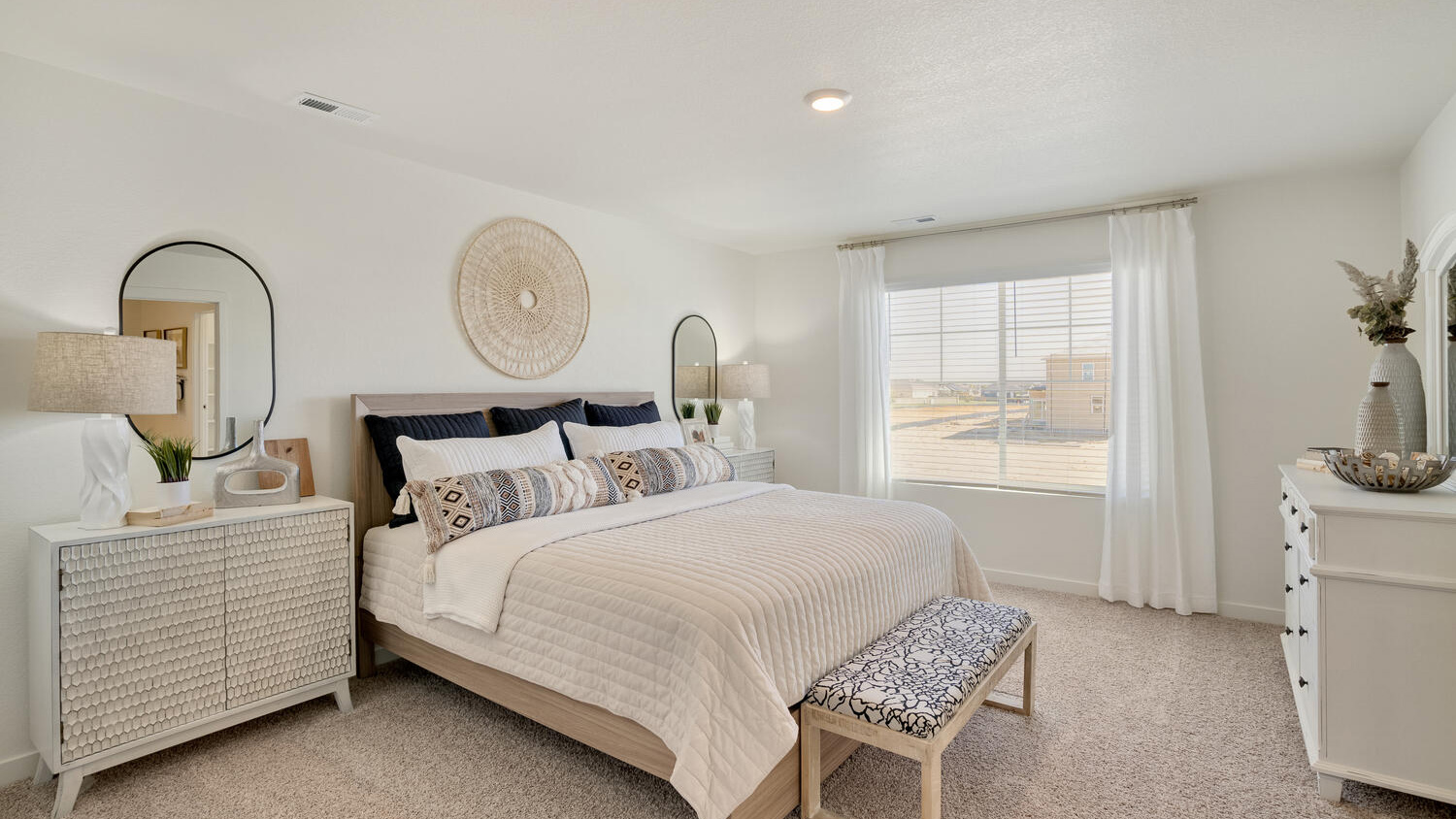 Private primary suite in the Elder floor plan featuring a spacious layout and two walk-in closets.