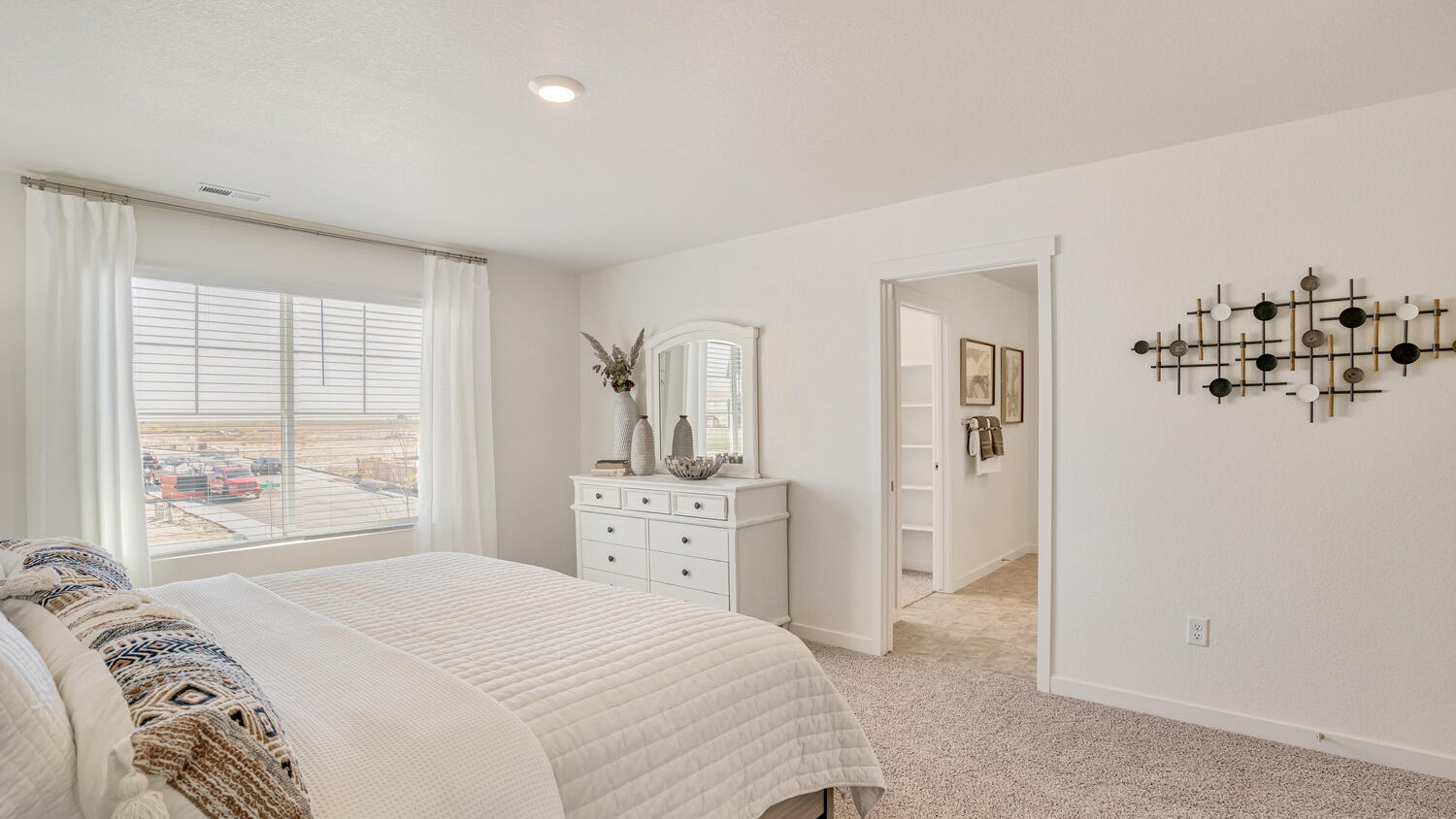 Elegant primary bedroom in the Elder home offering comfort, privacy, and generous closet space.