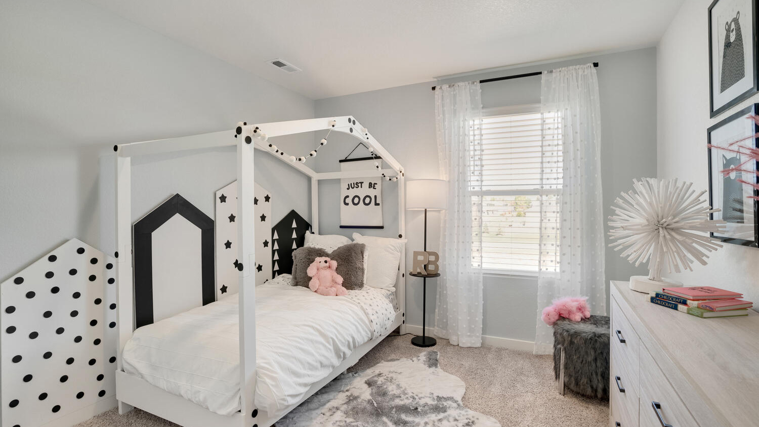 Bright guest bedroom in the Elder home with comfortable living space and natural light.