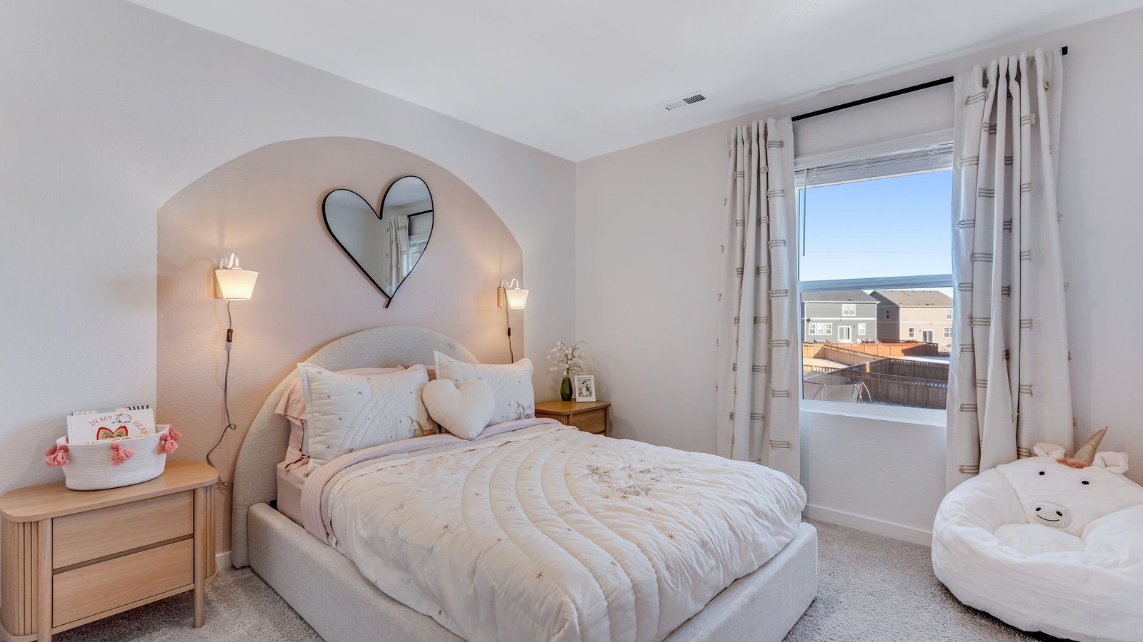 secondary bedroom with large windows in new home by d.r. horton severance, co