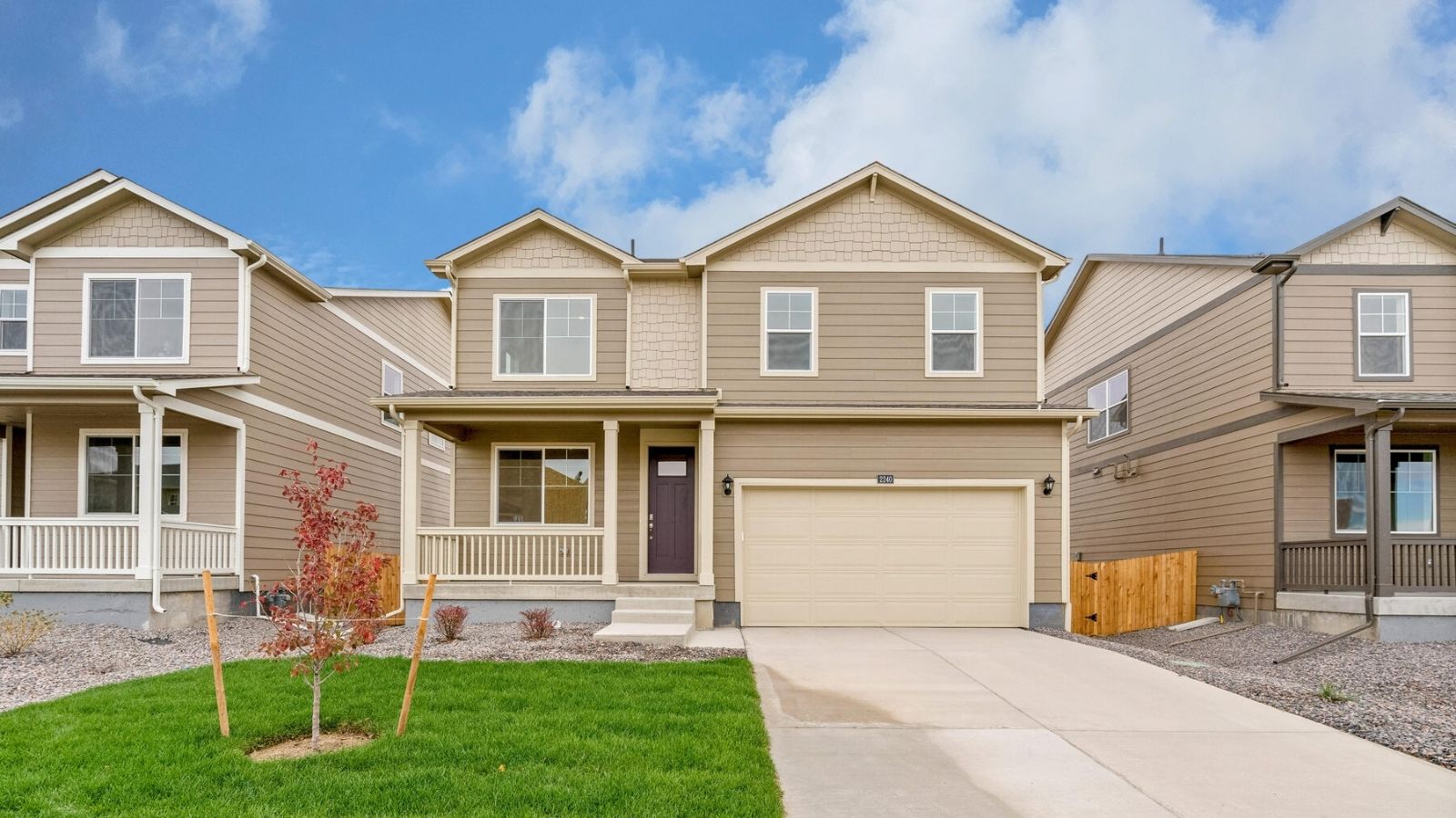 Exterior of the Pendleton floor plan at Tailholt featuring a south-facing homesite, charming curb appeal, and professionally landscaped front yard.
