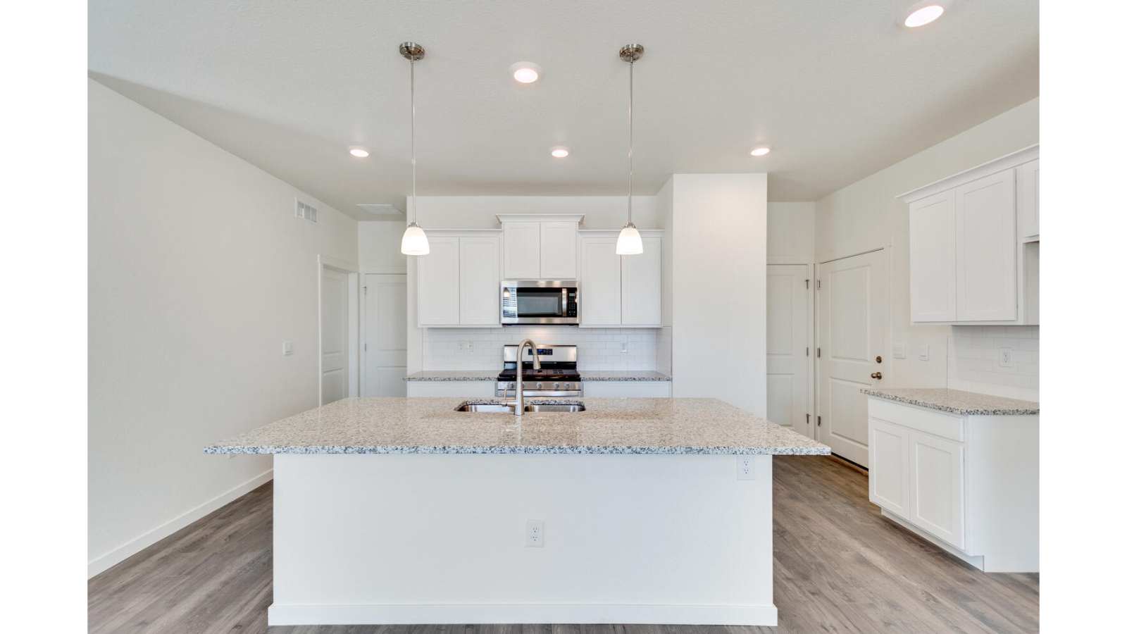 large kitchen island and stainless steel appliances