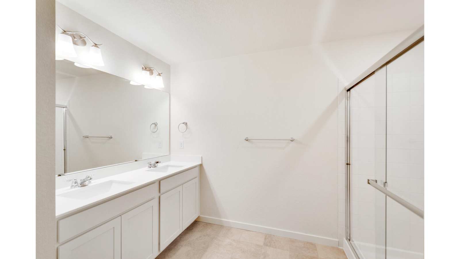 primary bath with dual sinks and shower