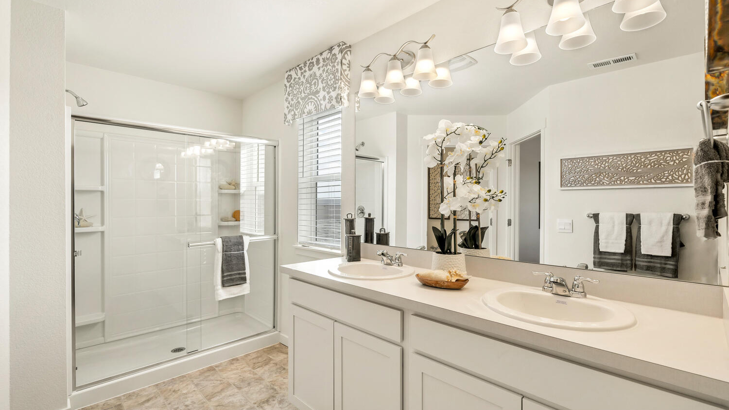 Primary bathroom with white cabinets