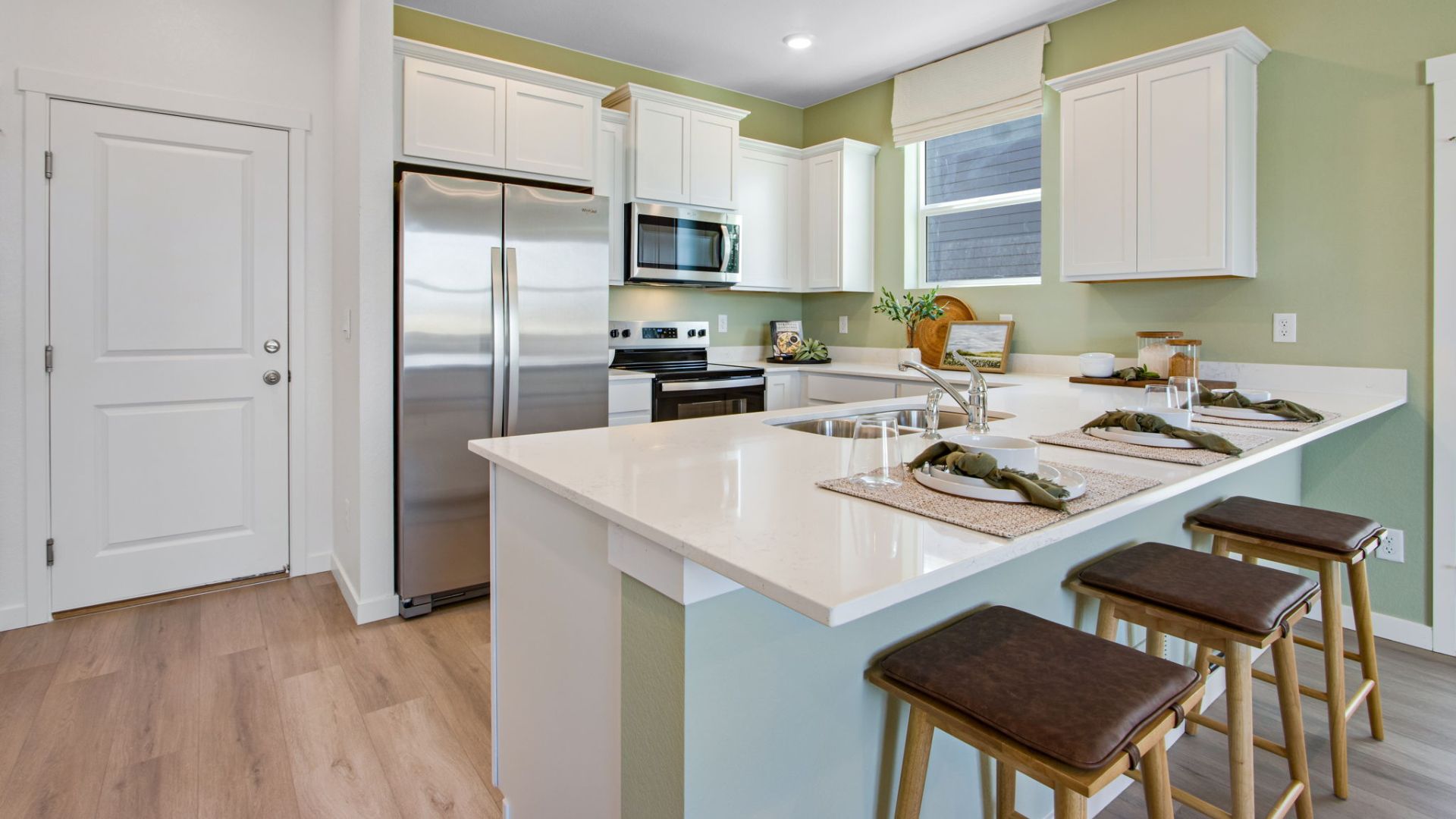 kitchen with white cabinets in new model home colorado