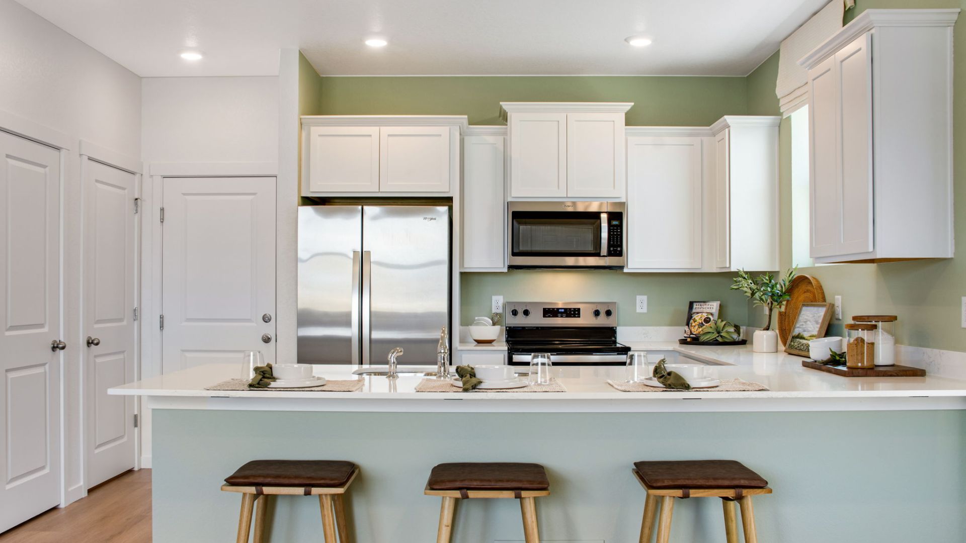 Modern New Haven kitchen with white cabinetry, expansive counter space, and pantry storage.