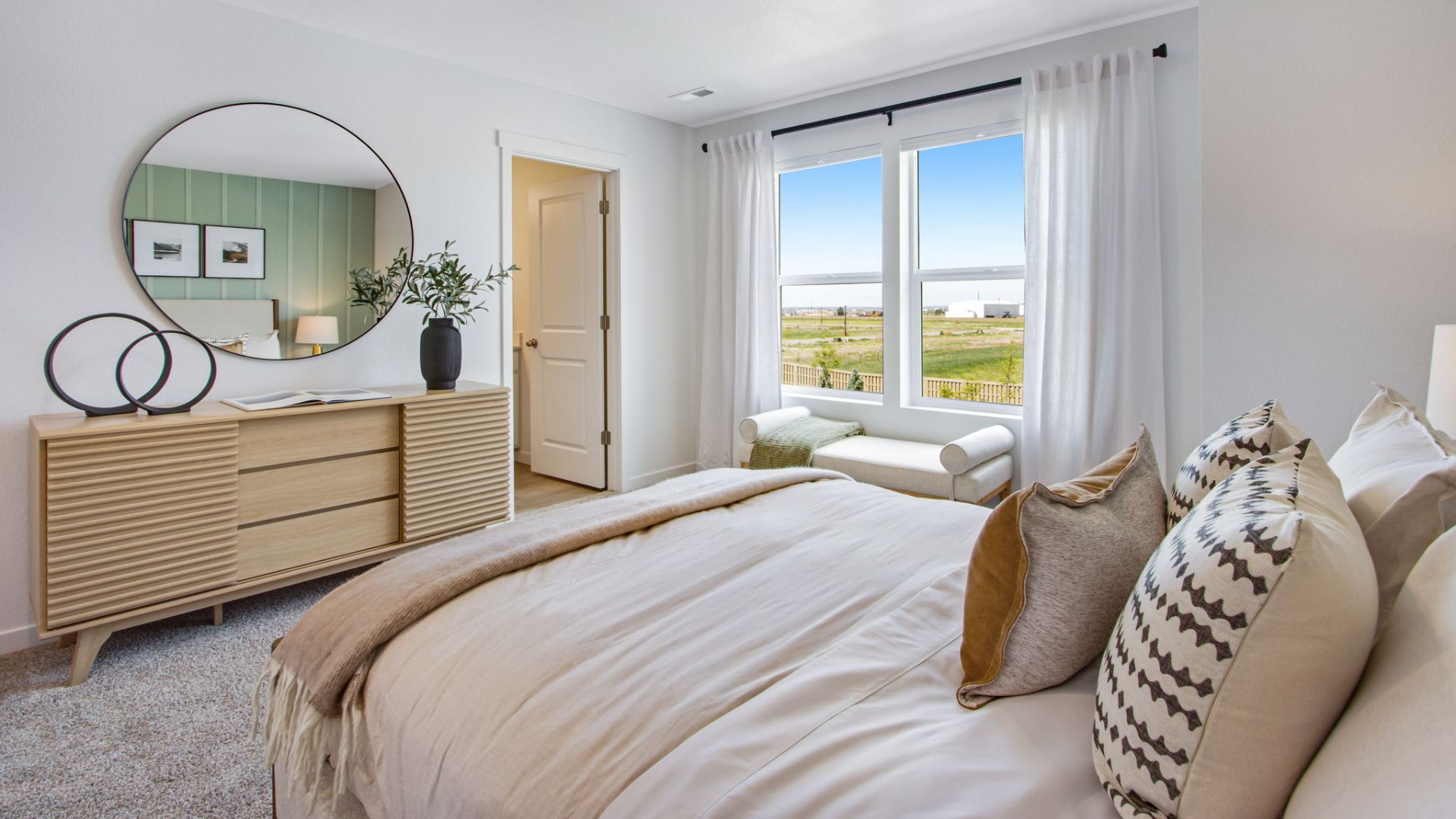 Private primary suite offering a comfortable retreat with modern finishes.