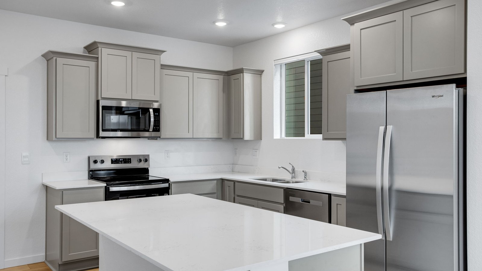 Modern kitchen featuring a large center island, abundant counter space, and a spacious pantry for extra storage.