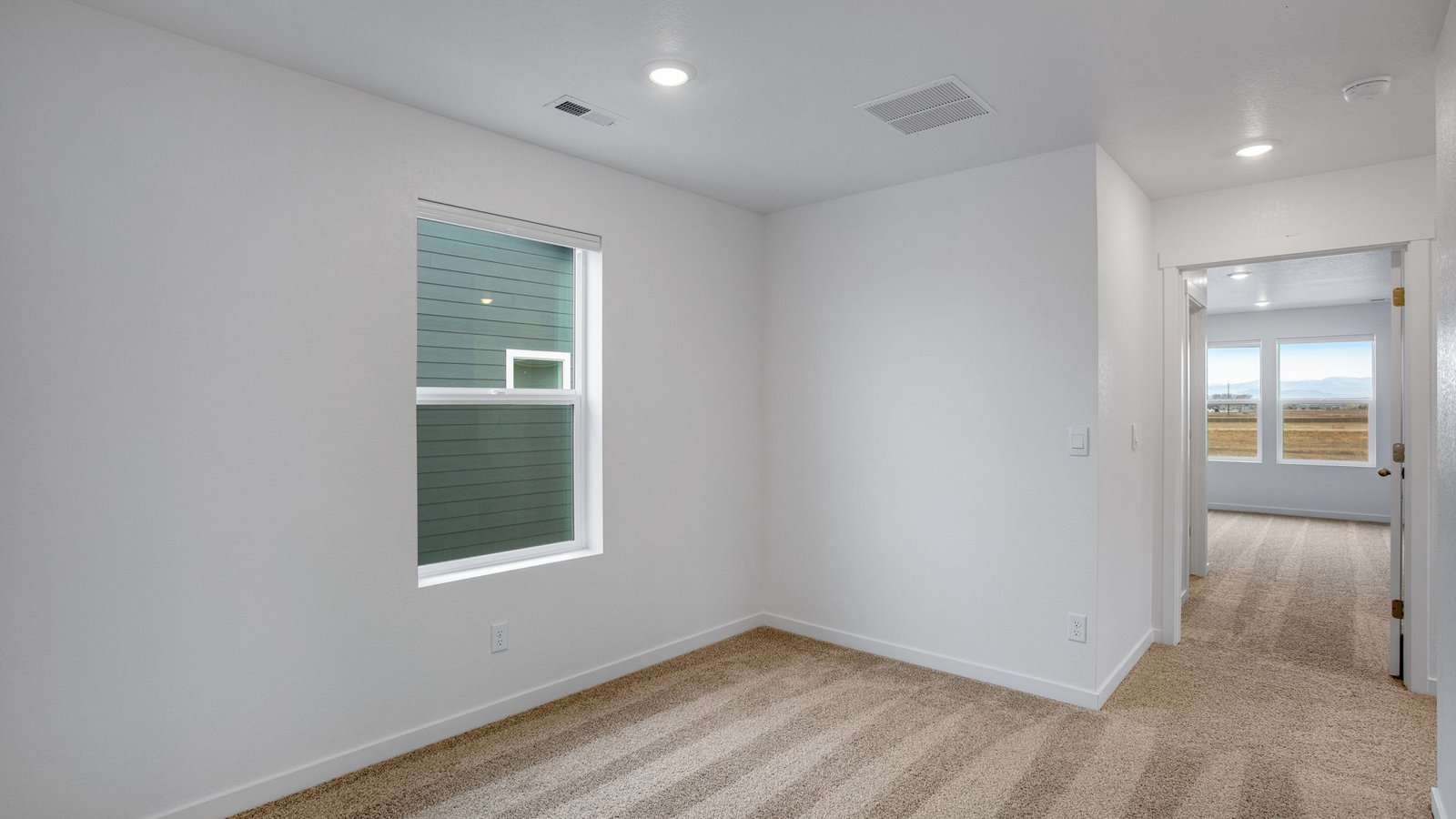 Flexible upstairs loft ideal for a home office, media room, play area, or relaxation space.