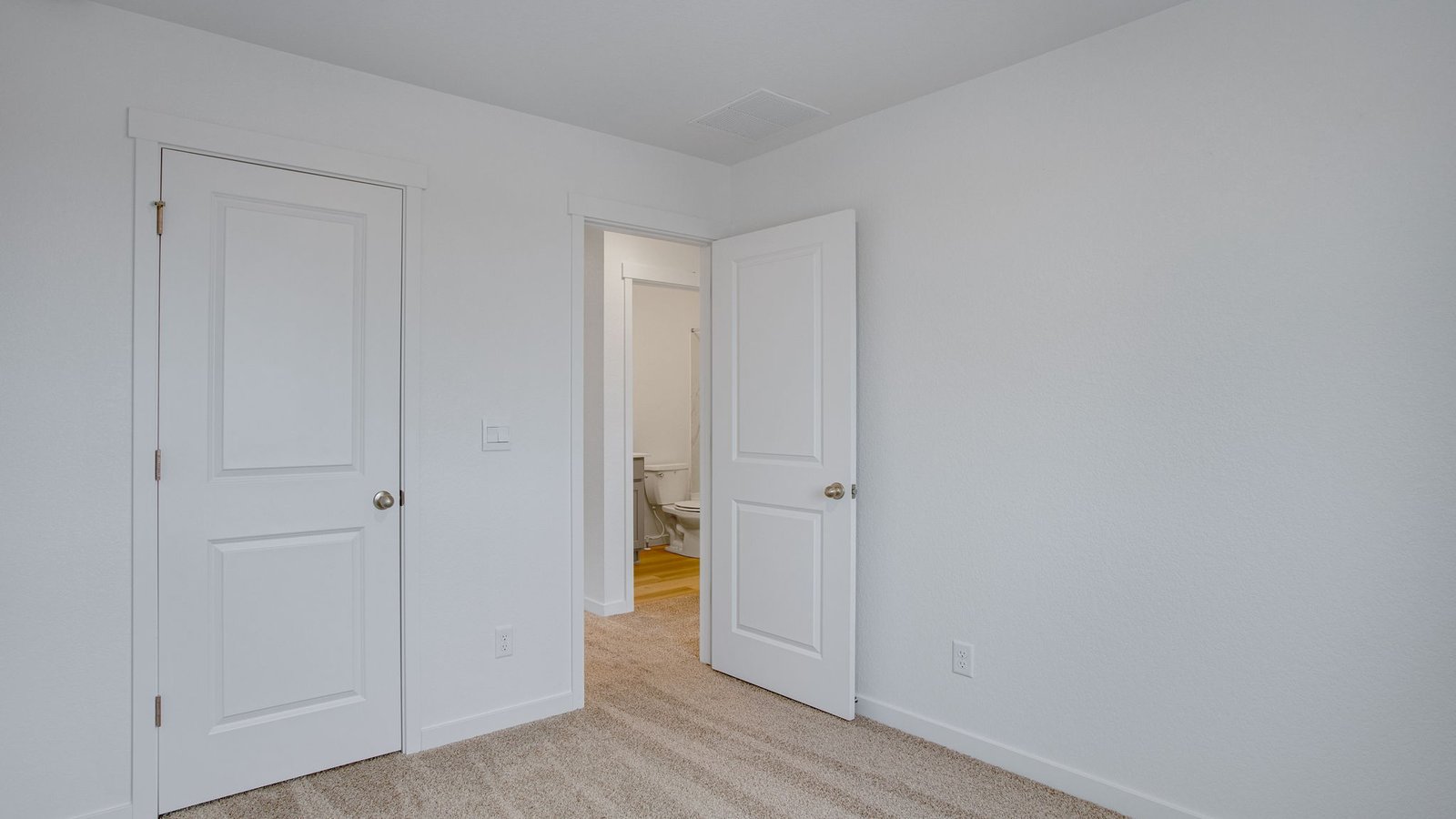 Comfortable bedroom with modern finishes and convenient access to the upstairs bathroom.