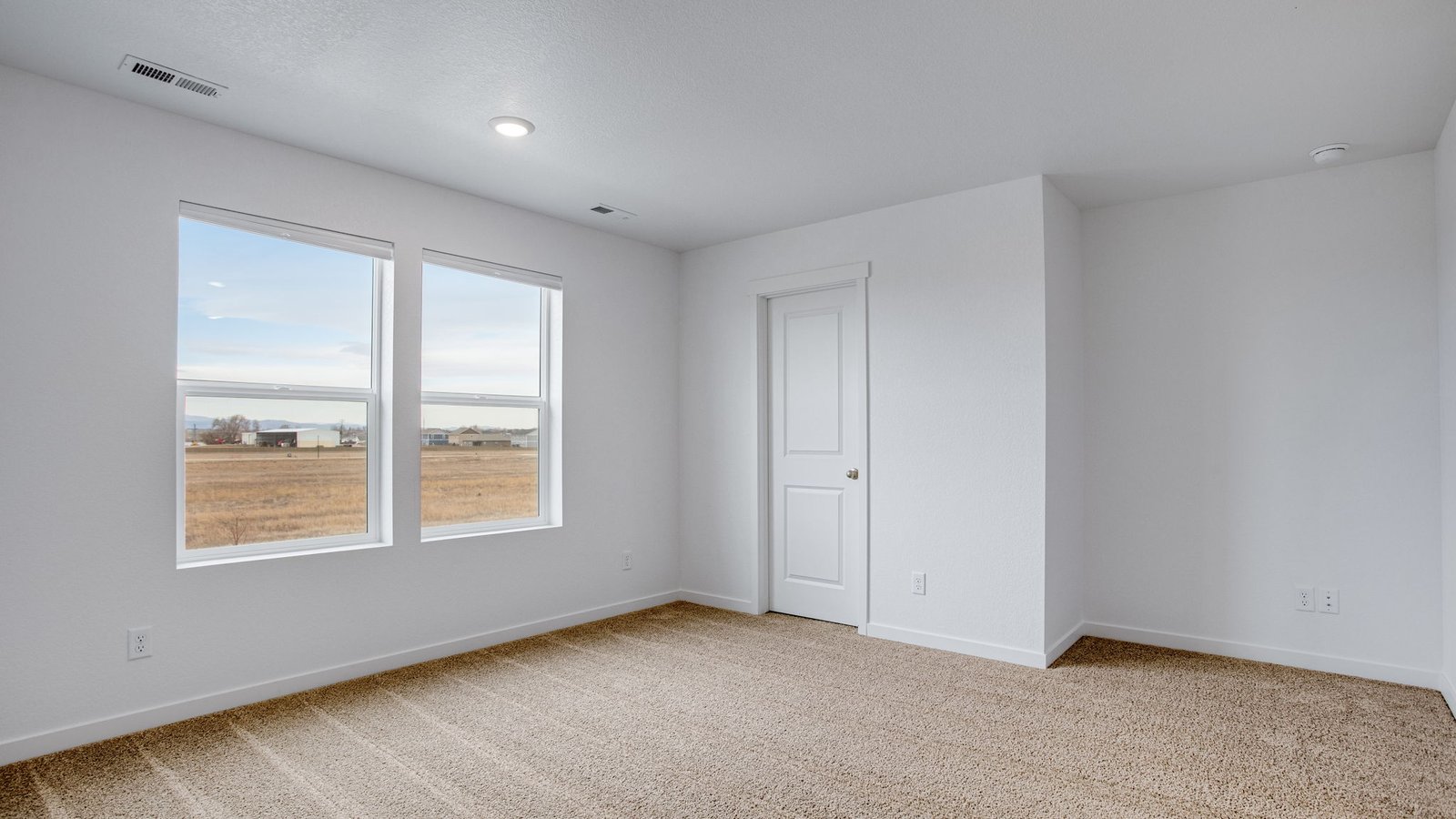 Private primary suite offering a spacious layout, natural light, and a comfortable retreat atmosphere.