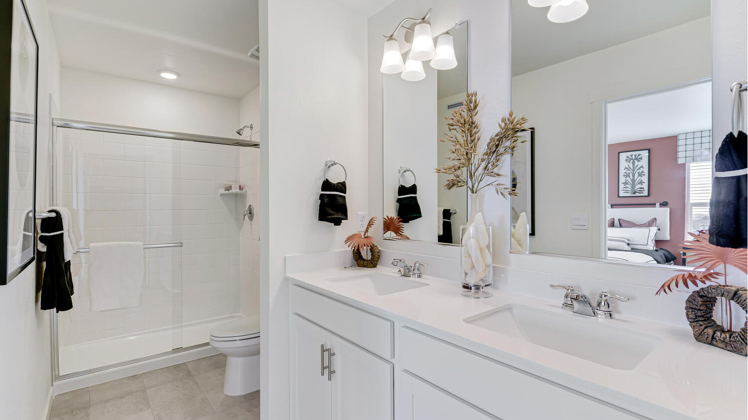Primary bathroom with dual sinks, contemporary finishes, and a functional layout.