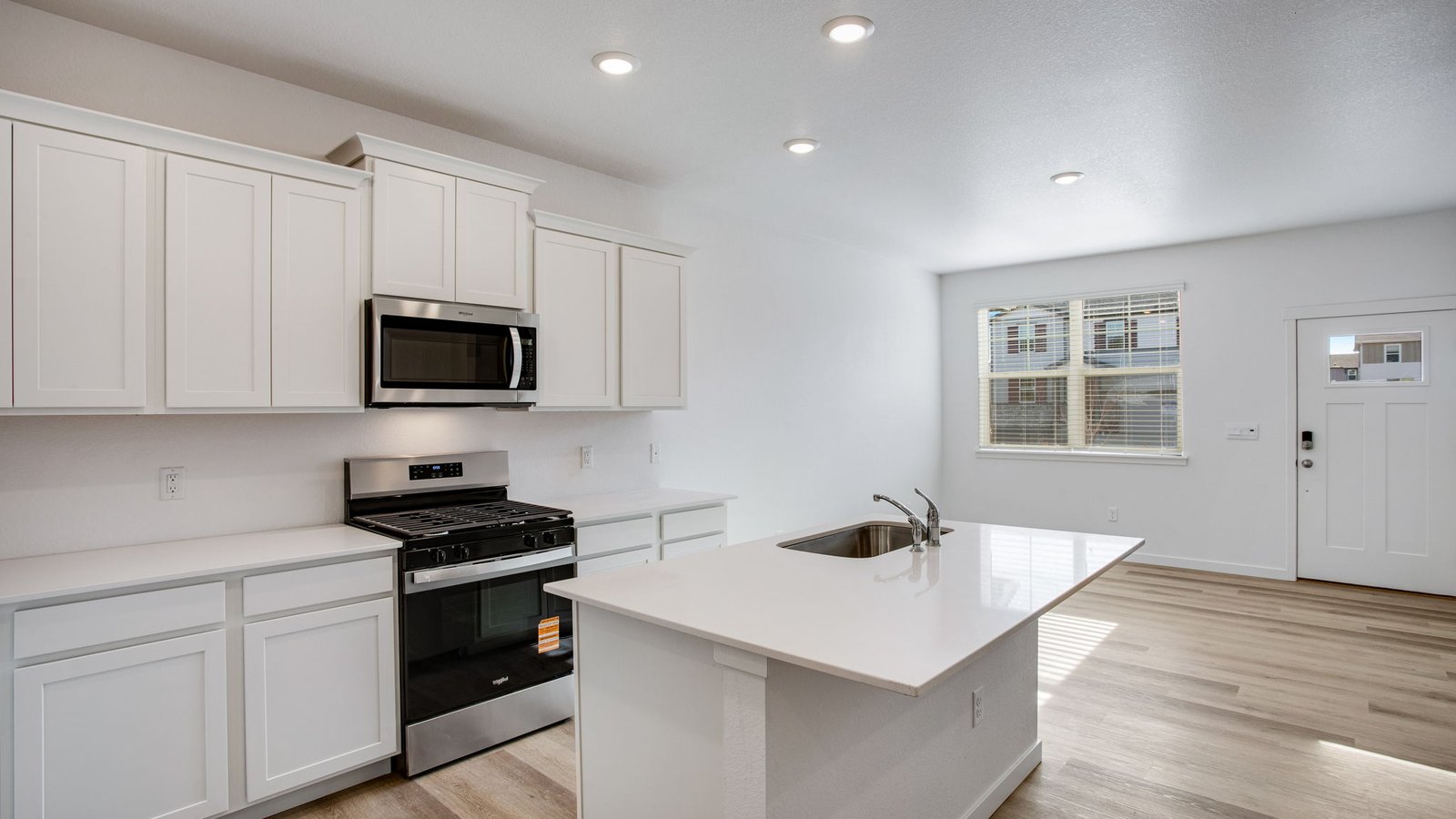 New kitchen with white cabinets and quartz countertops