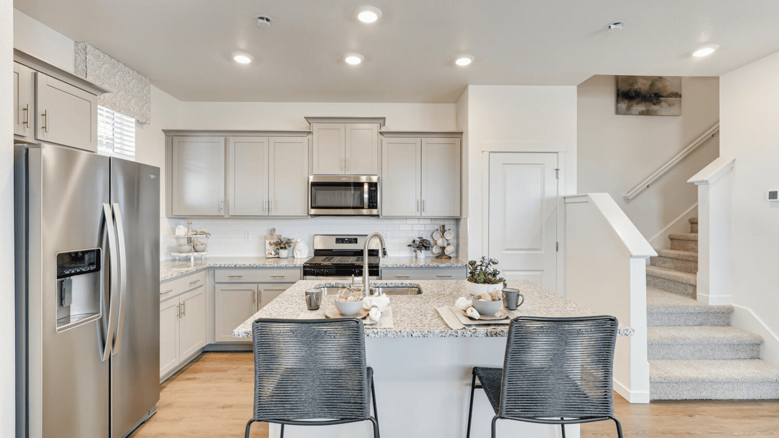Modern kitchen with light gray cabinets in new D.R. Horton home in Johnstown, CO